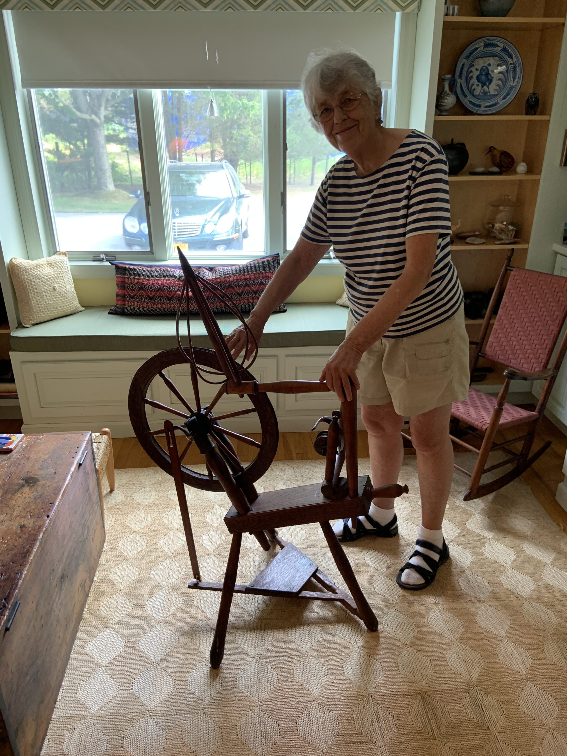 Ann Sandford with a spinning wheel she salavaged from the John Sandford House before her family sold it. STEPHEN J. KOTZ