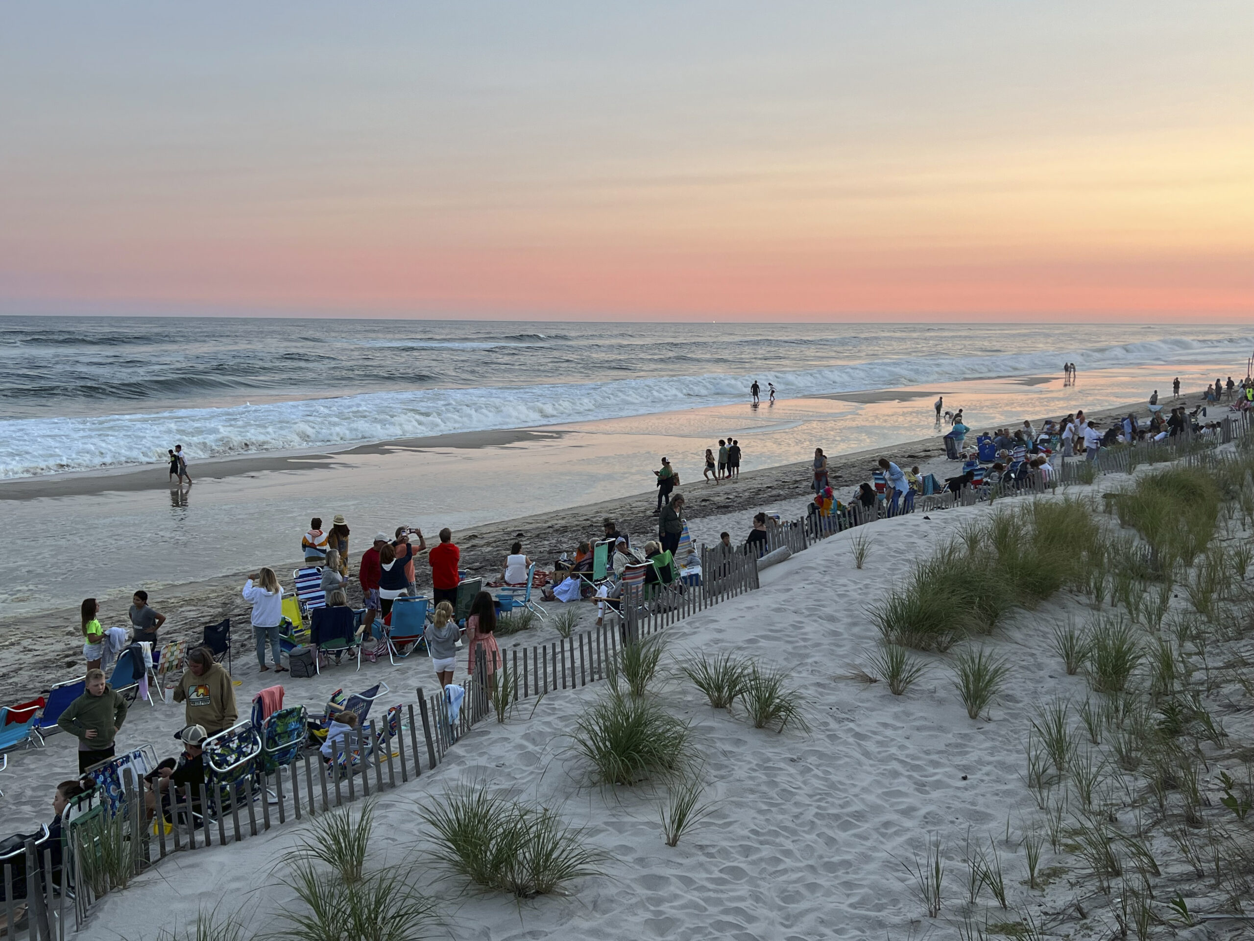 Folks gather on the beach to watch the fireworks.