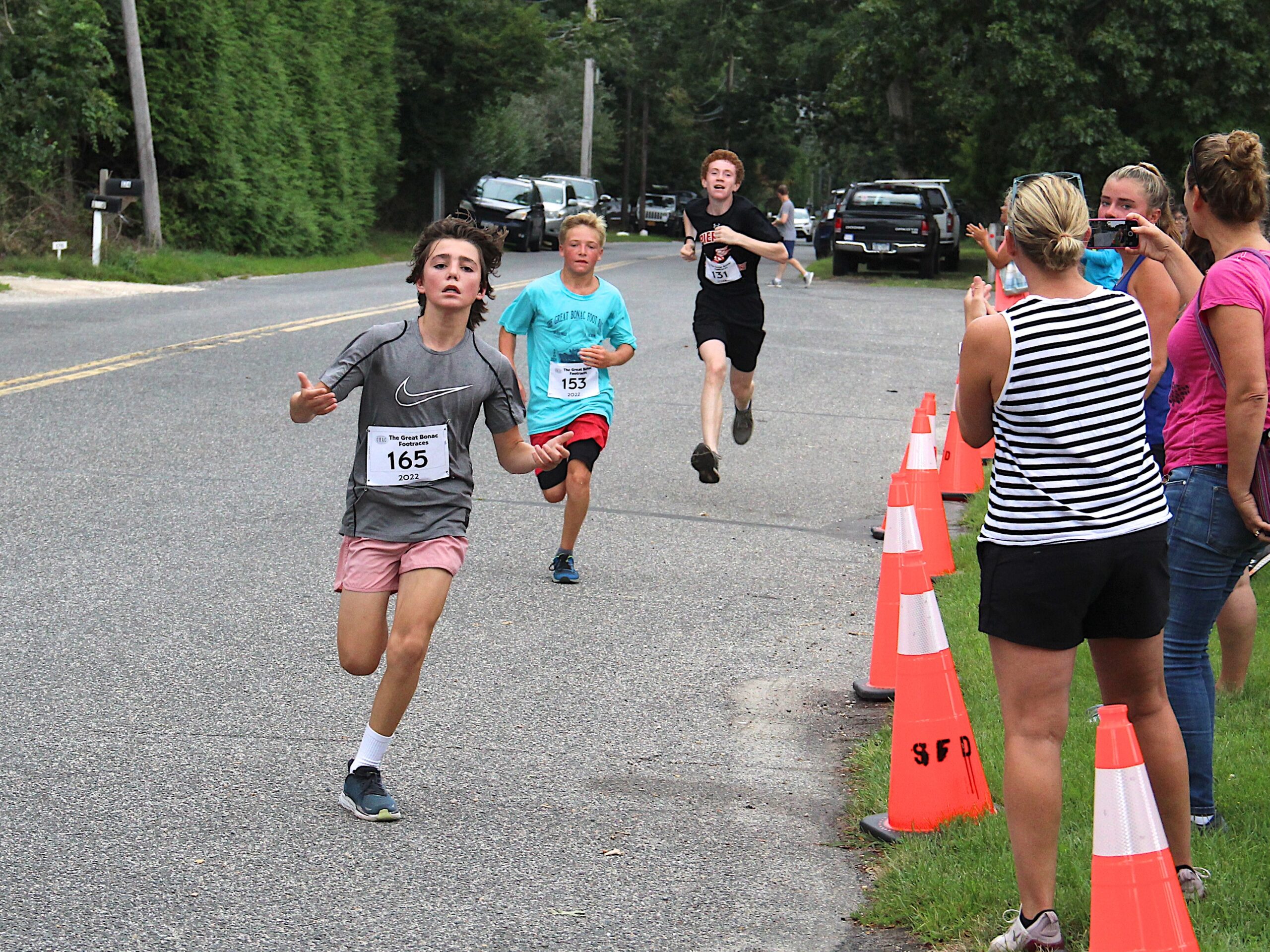 Evan Schaefer, 14, of East Hampton finishes up the 5K.     KYRIL BROMLEY