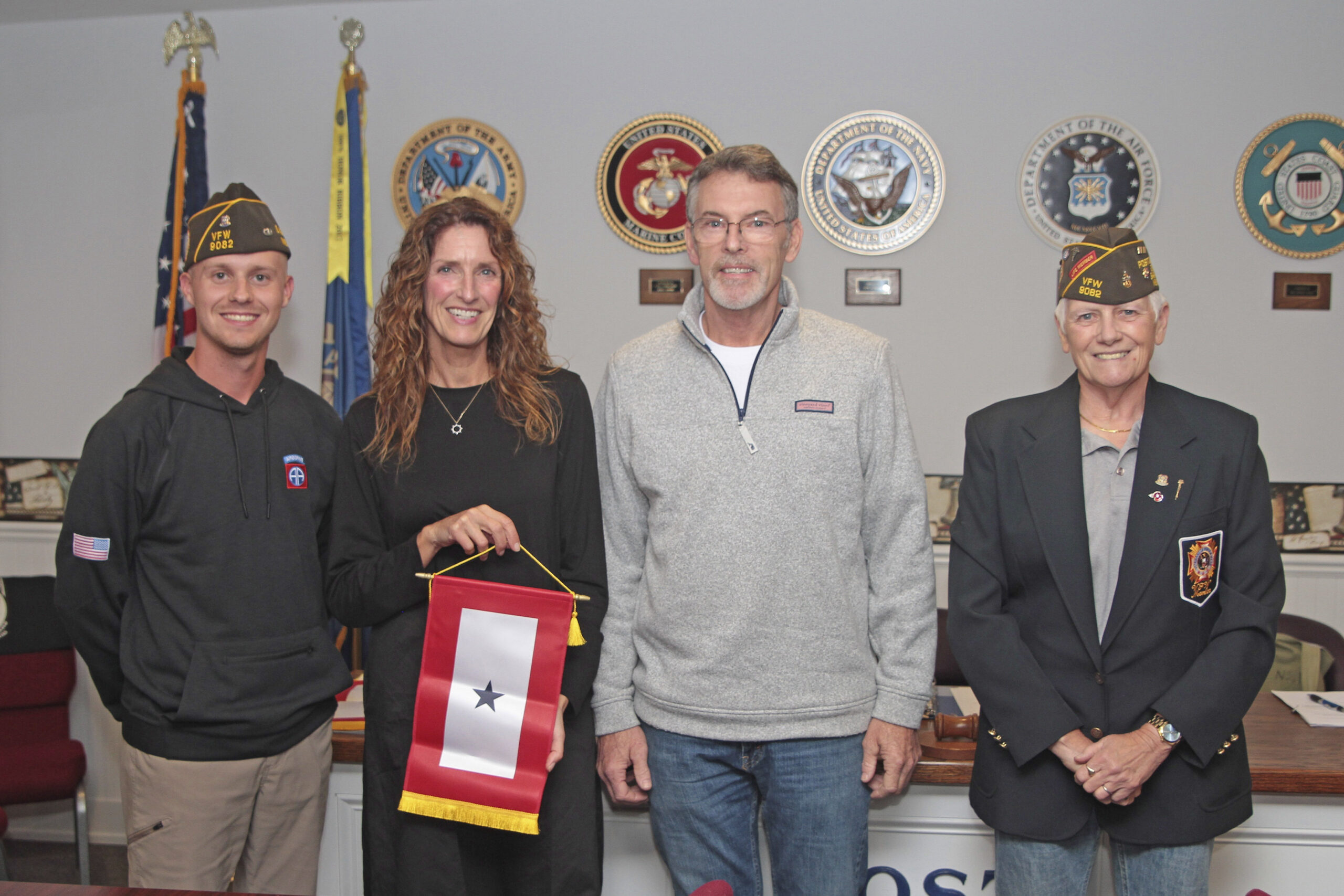 The Sag Harbor VFW recognized Blue Star families on  October 17. Left to right are: Max Yardley, with Chris and Patrick Witty and Sharon Lewis. It’s an American tradition to display a Blue Star Service Banner in the window of a home when a loved one serving in the U.S. Armed Forces. The blue star represents one family member serving, and a banner can have up to five stars.   TOM KOCHIE