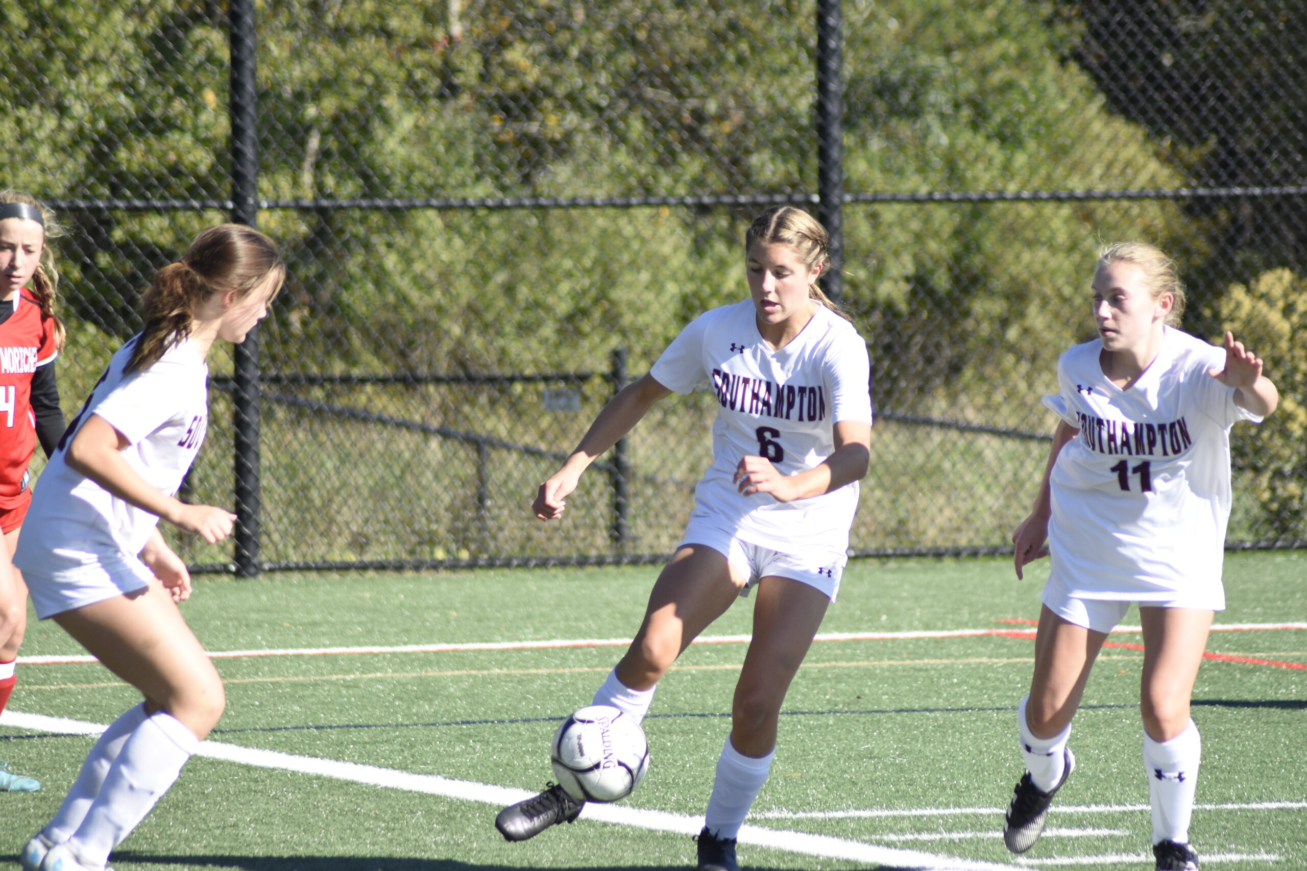 Sophomore Vivienne Archer leads a clearing attempt by the Mariners defense.   DREW BUDD