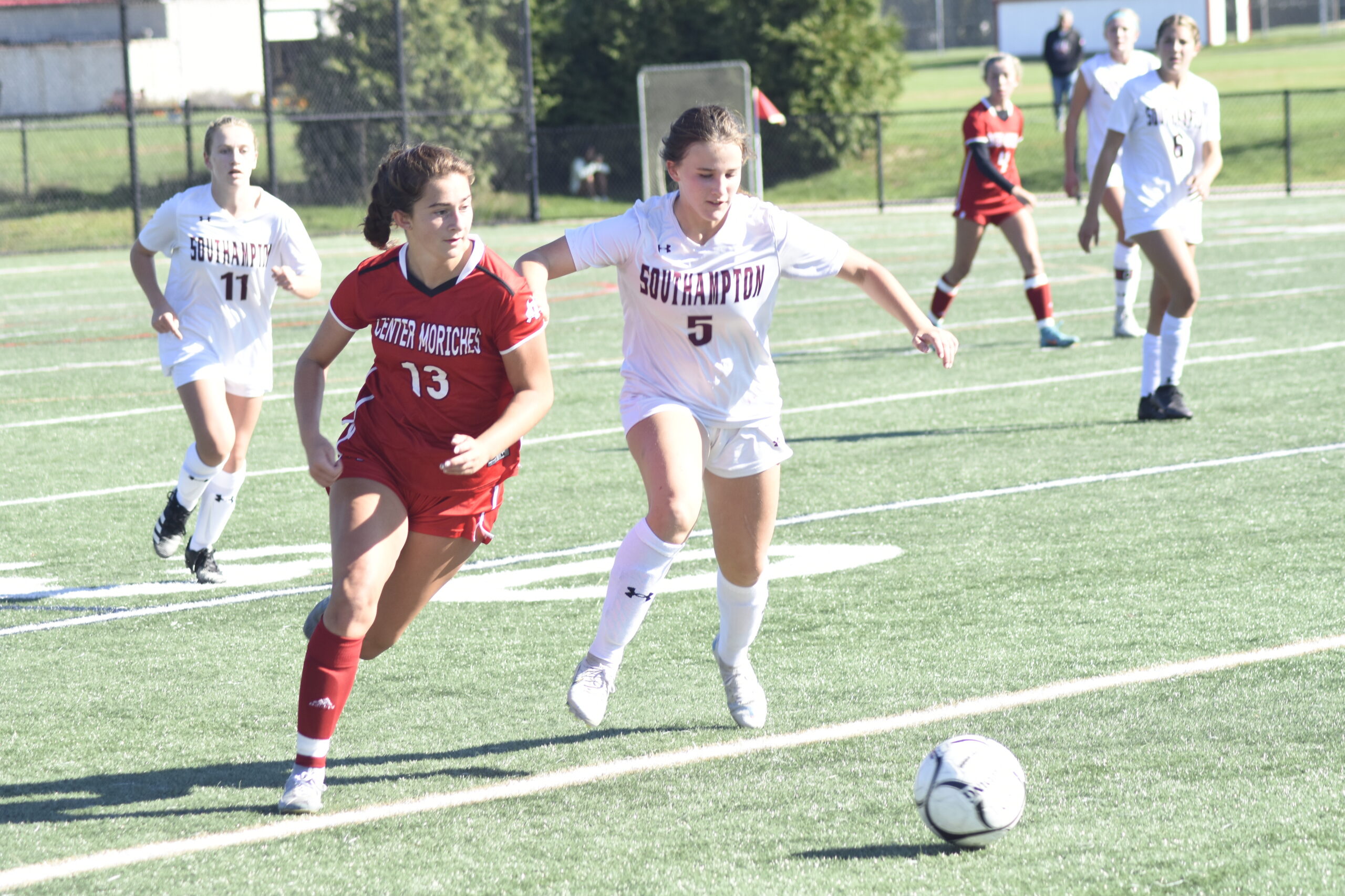 Southampton sophomore Harper Souhrada and a Center Moriches player race toward the ball.   DREW BUDD