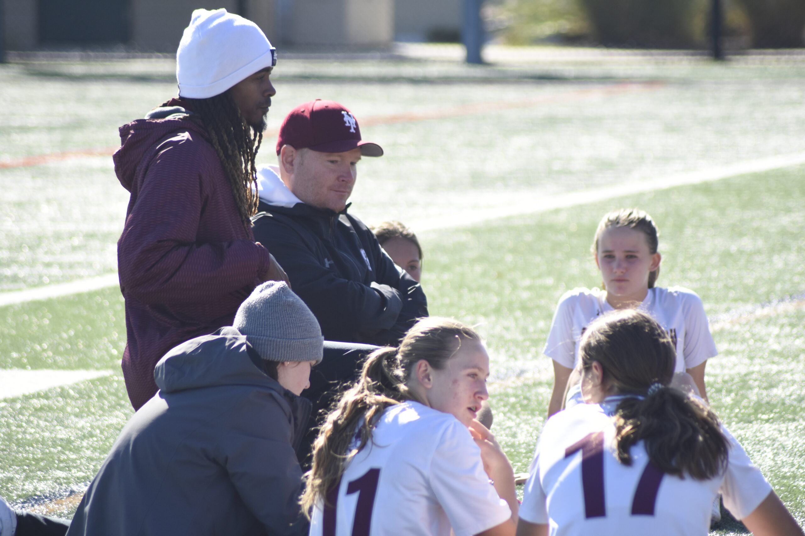 Assistant coach Davin Johnson and head coach Sean Zay talk to their players at halftime of Saturday's game in Center Moriches.    DREW BUDD