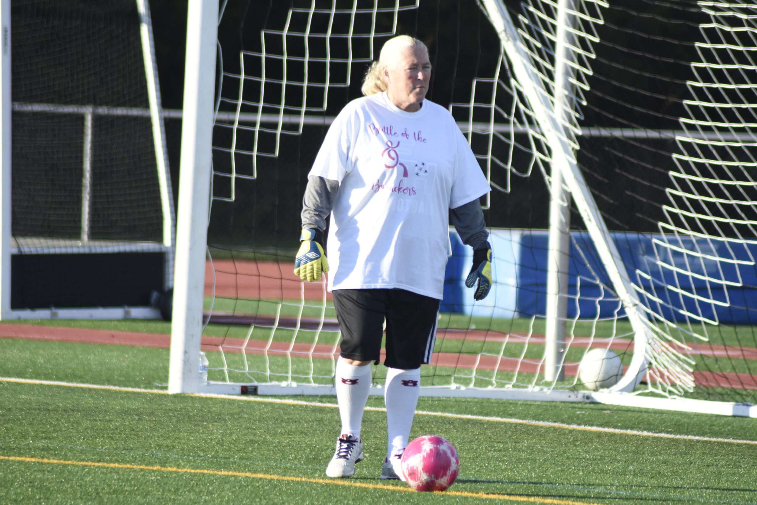 East Hampton Athletic Director Kathy Masterson played goalie for the white team.   DREW BUDD