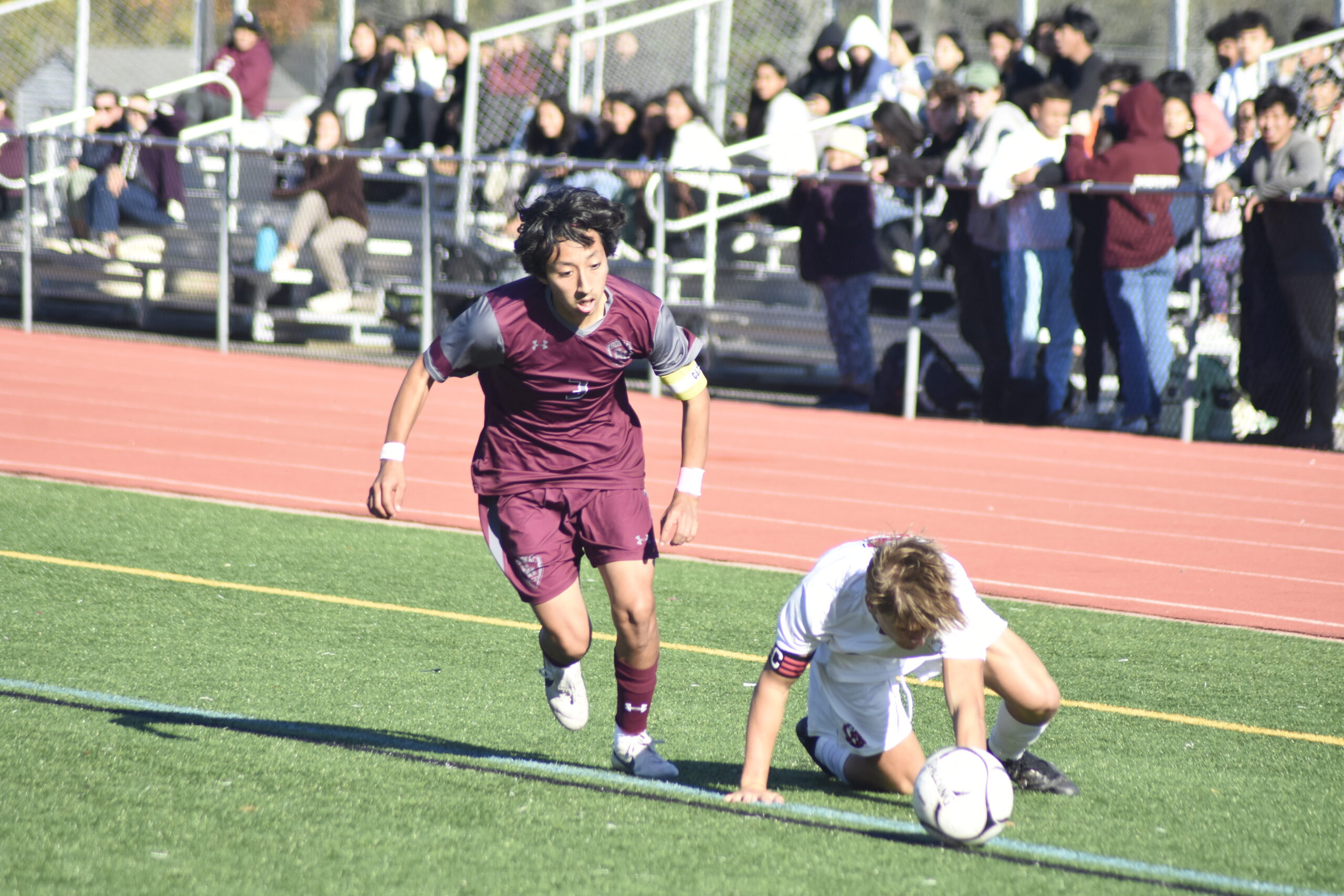 East Hampton junior co-captain Brian Tacuri leaves an East Islip player behind.    DREW BUDD