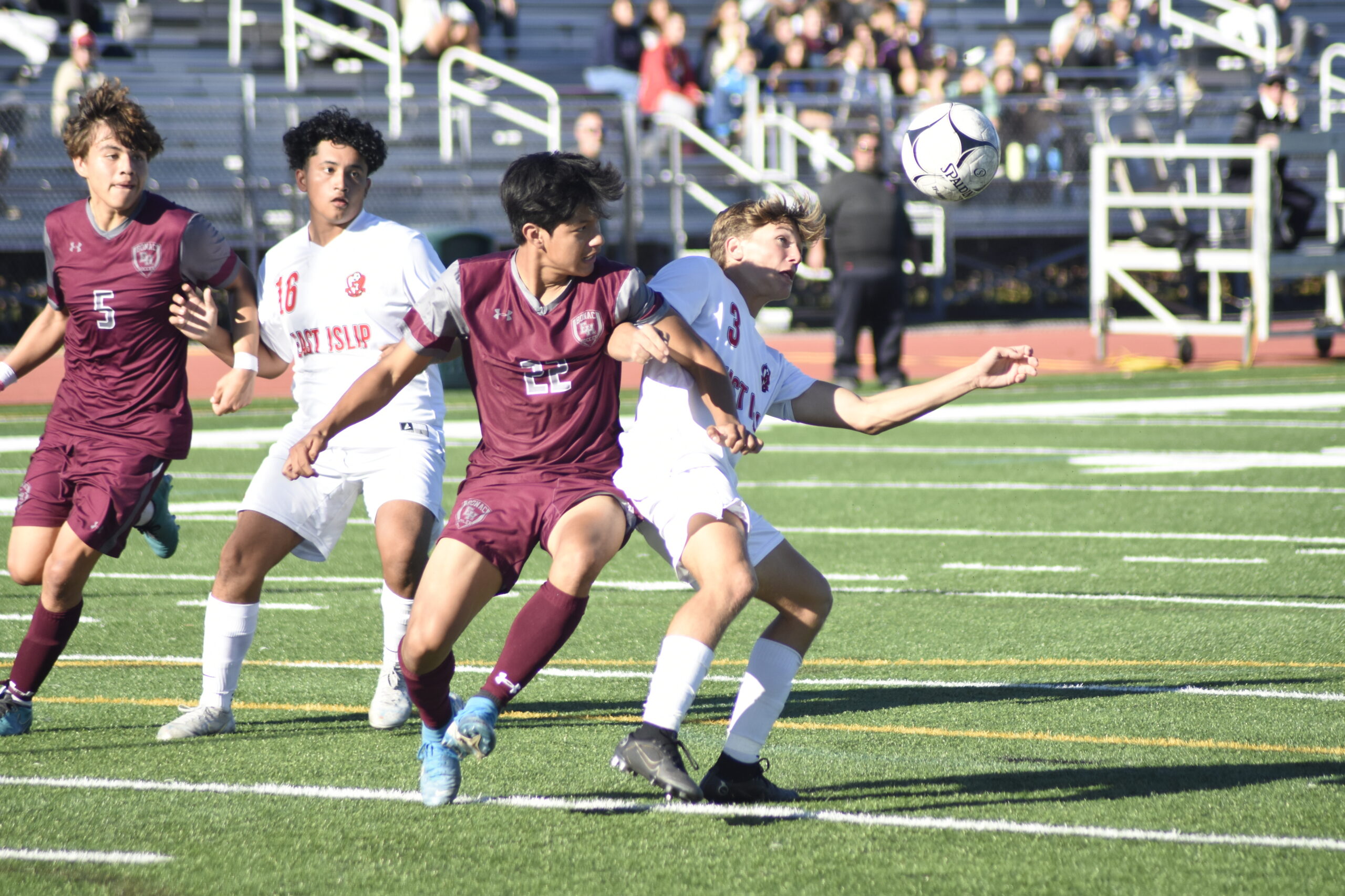 East Hampton senior Steve Baculima ties up with an East Islip player.    DREW BUDD