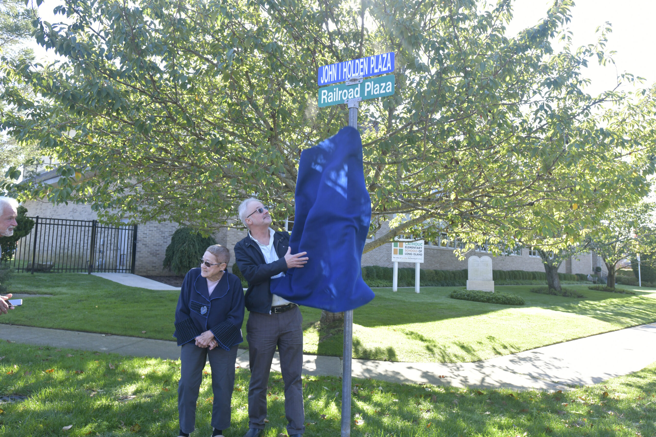 Mary (Holden) Maran and Lester Holden unveiling and dedication of the honorarily renaming of  Railroad Plaza to John I. Holden Plaza in Southampton Village on Saturday morning. Mr. Holden died last year at the age of 100. He was a World War II veteran, who volunteered his time to numerous community organizations such as the Rotary Club, the Boy Scouts, and the Southampton Fresh Air Home. His love for veterans led him to placing American Flags at the graves of those who served our country every Memorial Day and Veterans Day. John estimated he placed thousands of flags during the many years he carried out this tradition.   DANA SHAW