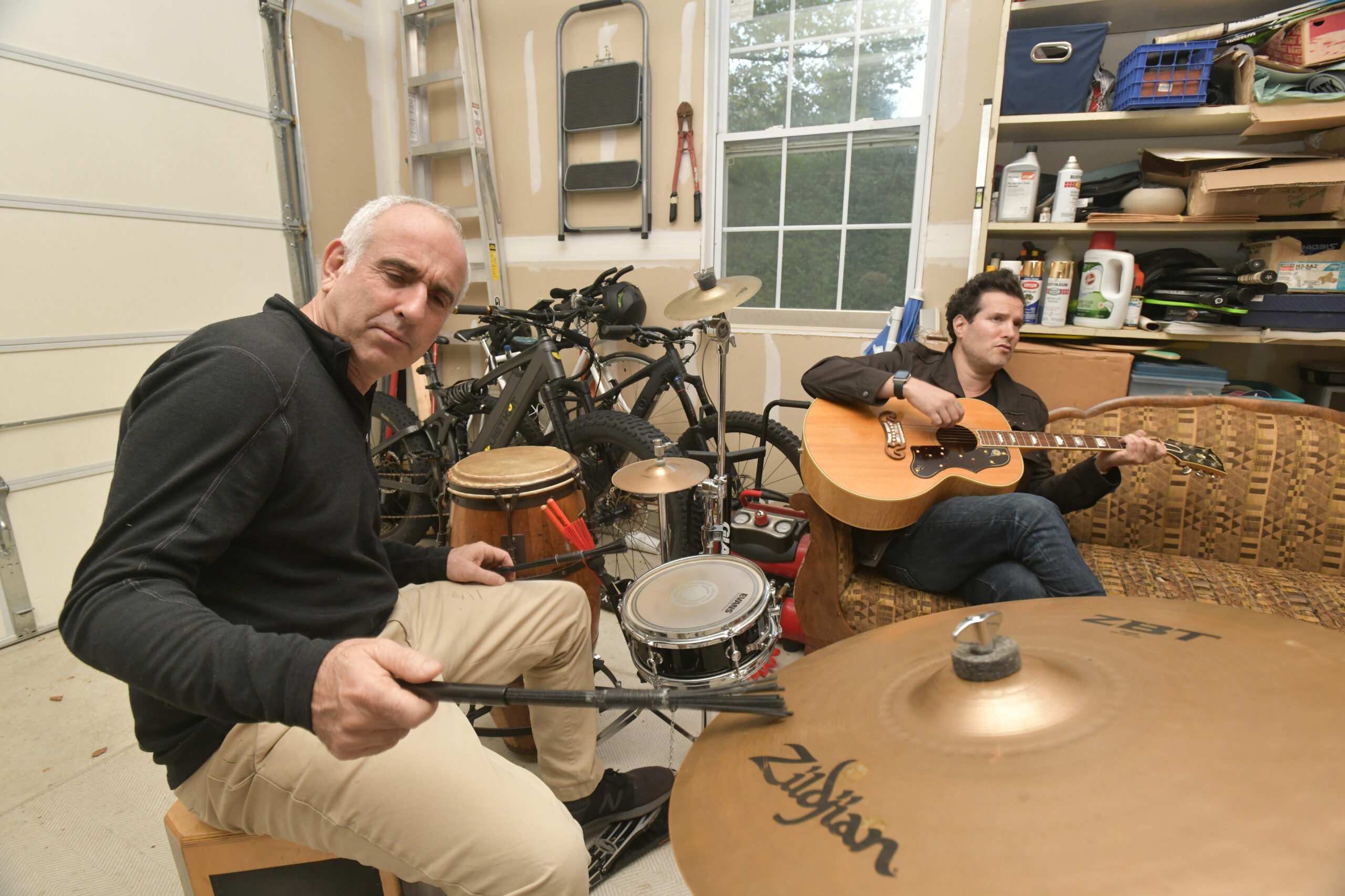 Jay Schneiderman and Matt White go over over some songs in Schneiderman's garage on Monday.  DNAA SHAW
