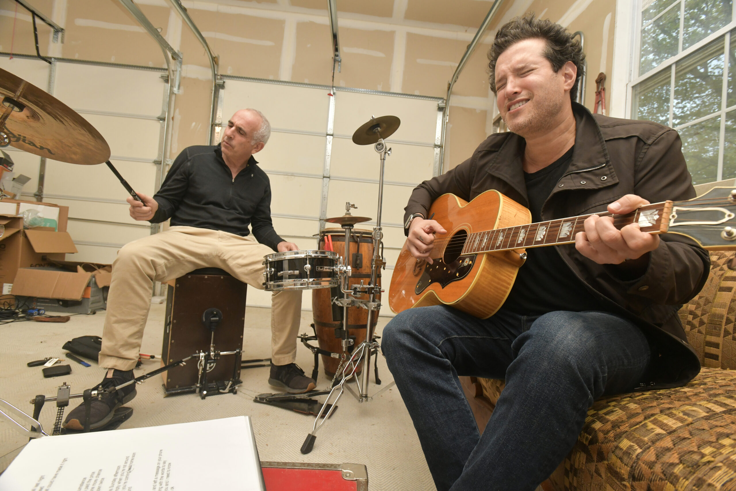 Jay Schneiderman and Matt White go over over some songs in Schneiderman's garage on Monday.  DNAA SHAW