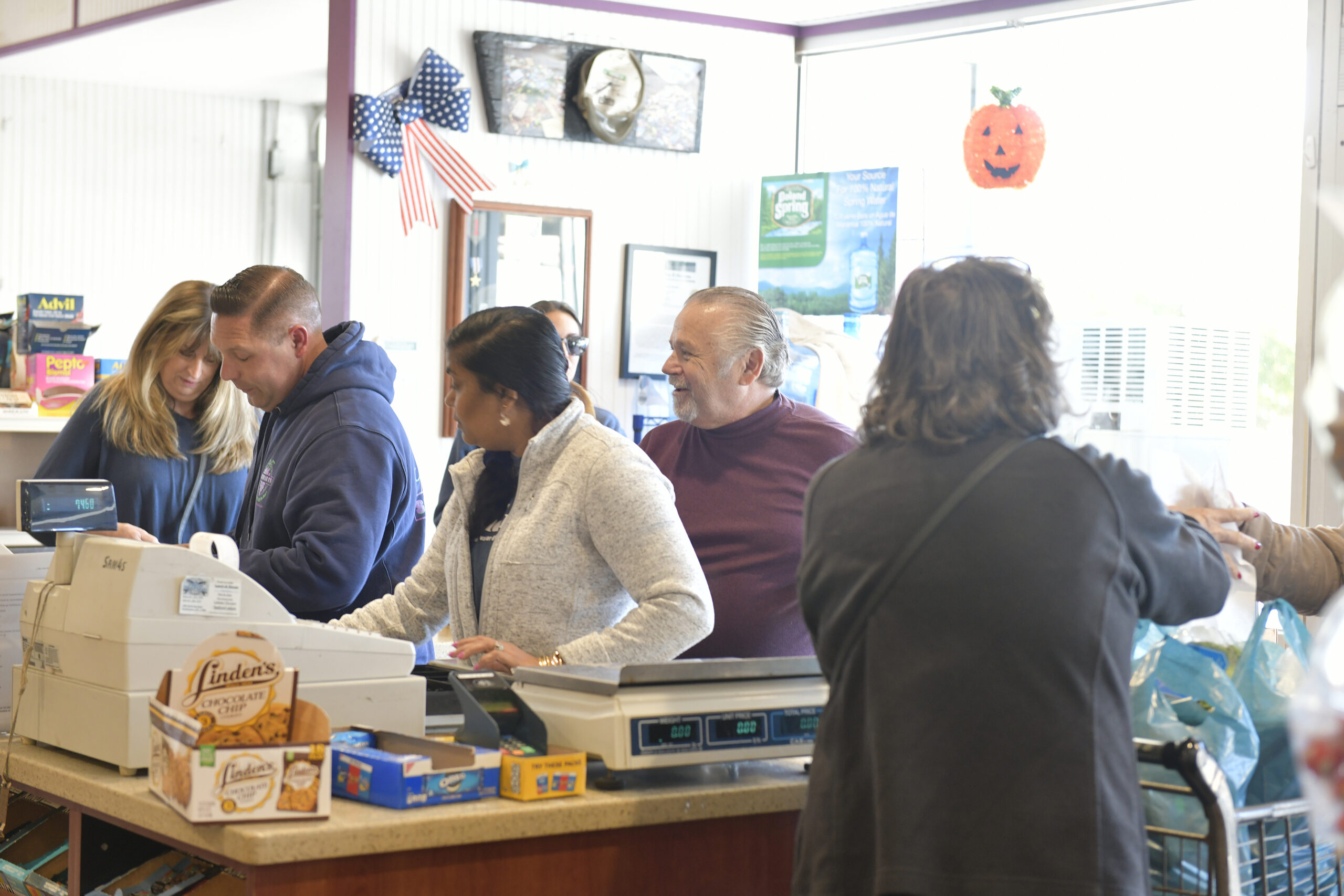 Dan and Dennis Schmidt check out customers and say their goodbyes on Friday at Schmidt's Market.  DANA SHAW