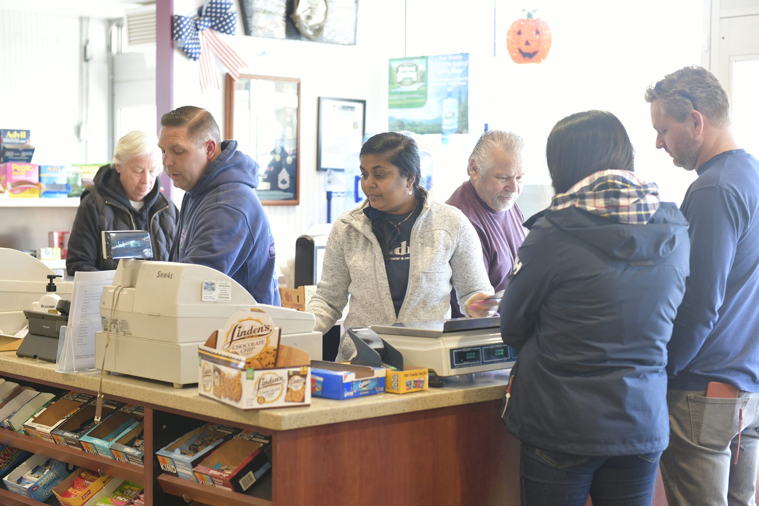 Dan and Dennis Schmidt check out customers and say their goodbyes on Friday at Schmidt's Market.  DANA SHAW