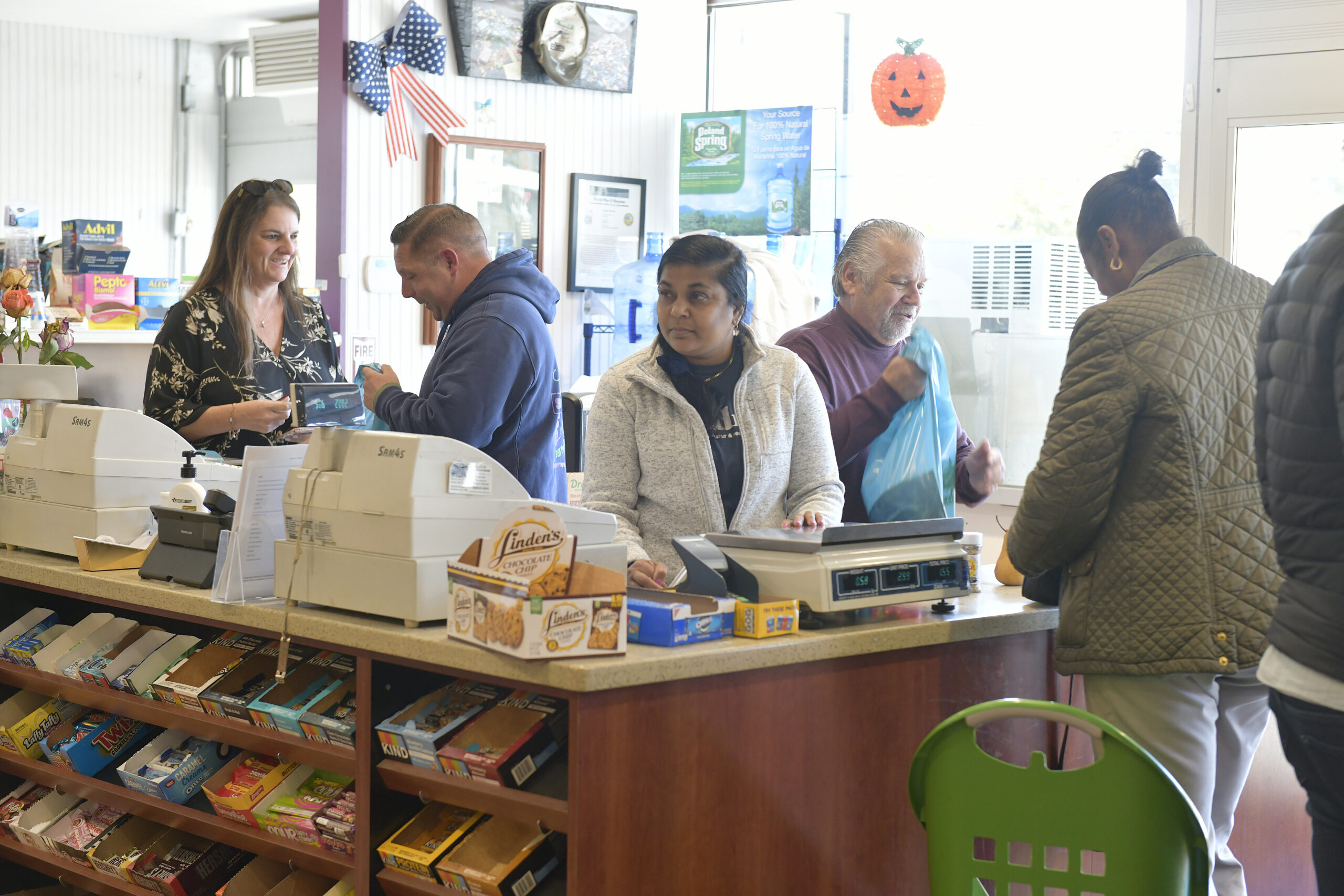 Dan and Dennis Schmidt check out customers and say their goodbyes on Friday at Schmidt's Market.  DANA SHAW