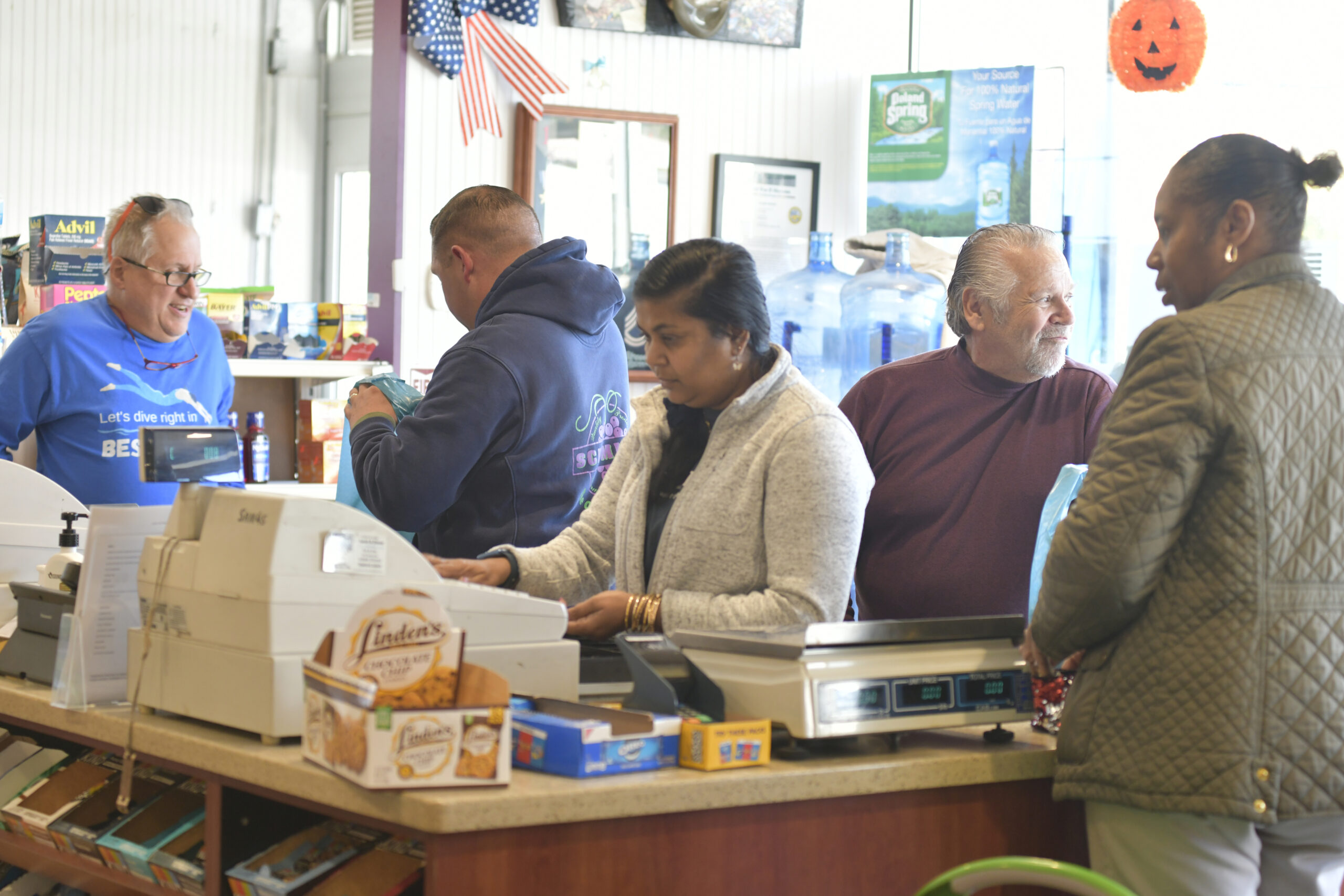 Dan and Dennis Schmidt check out customers and say their goodbyes on Friday at Schmidt's Market.  DANA SHAW