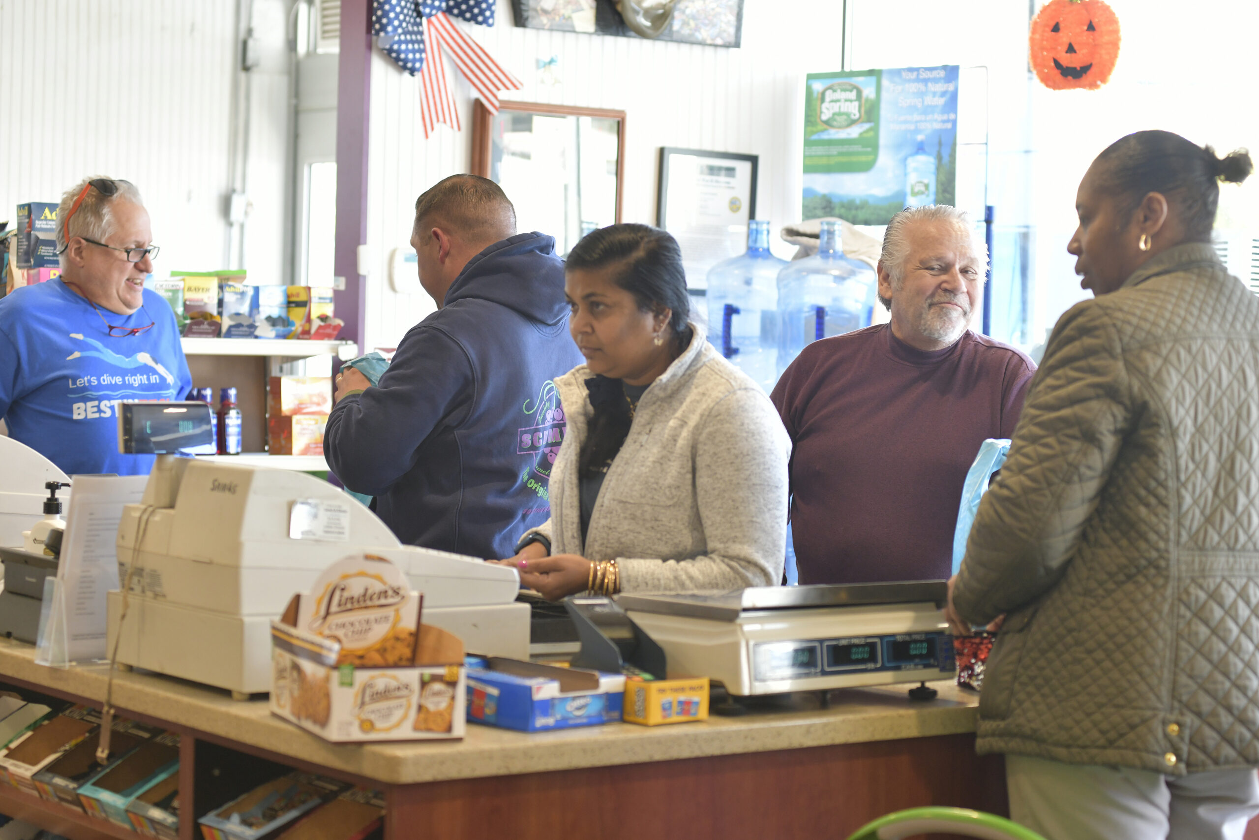 Dan and Dennis Schmidt check out customers and say their goodbyes on Friday at Schmidt's Market.  DANA SHAW