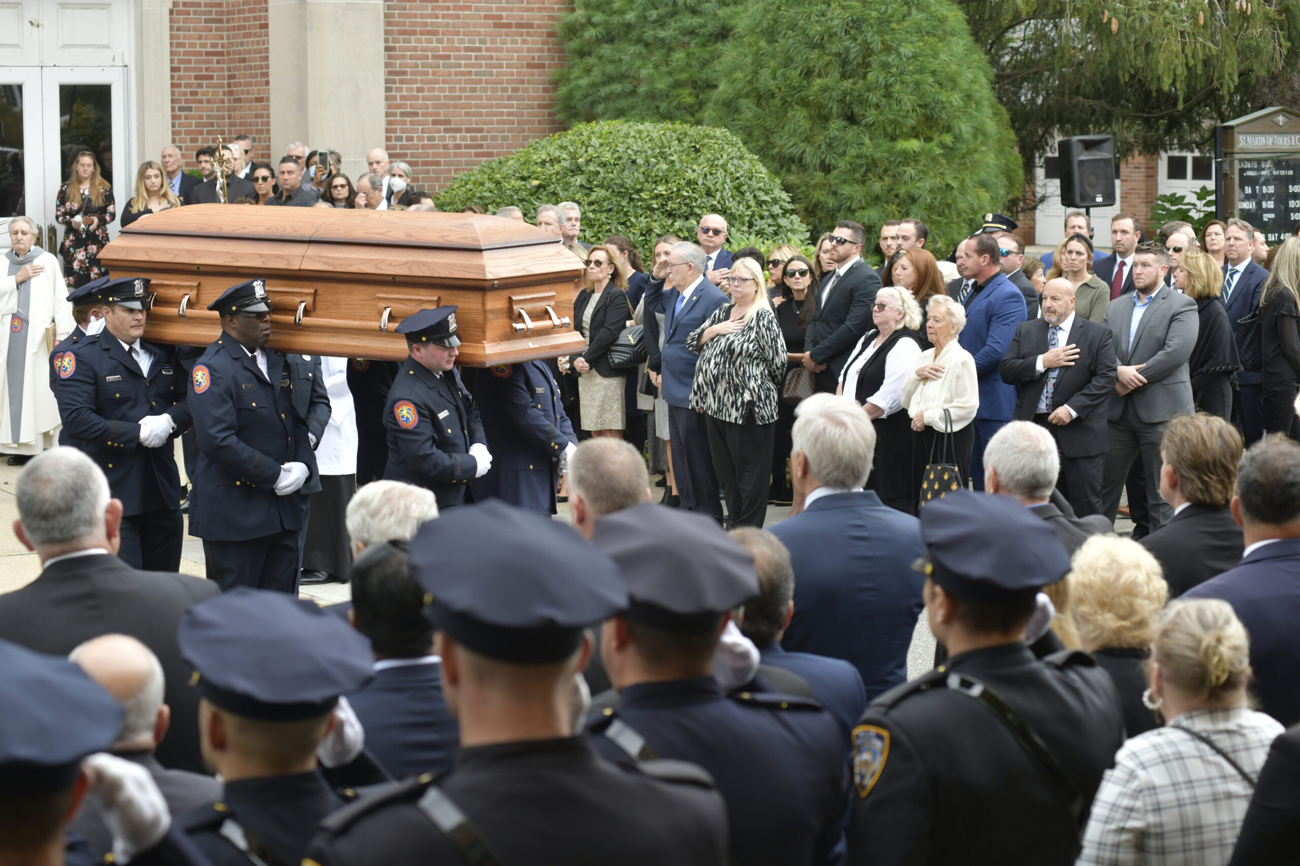 Pallbearers carry the casket of Southampton Police Chief Steven Skrynecki from St. Martin of Tours Church in Amityville on October 13.