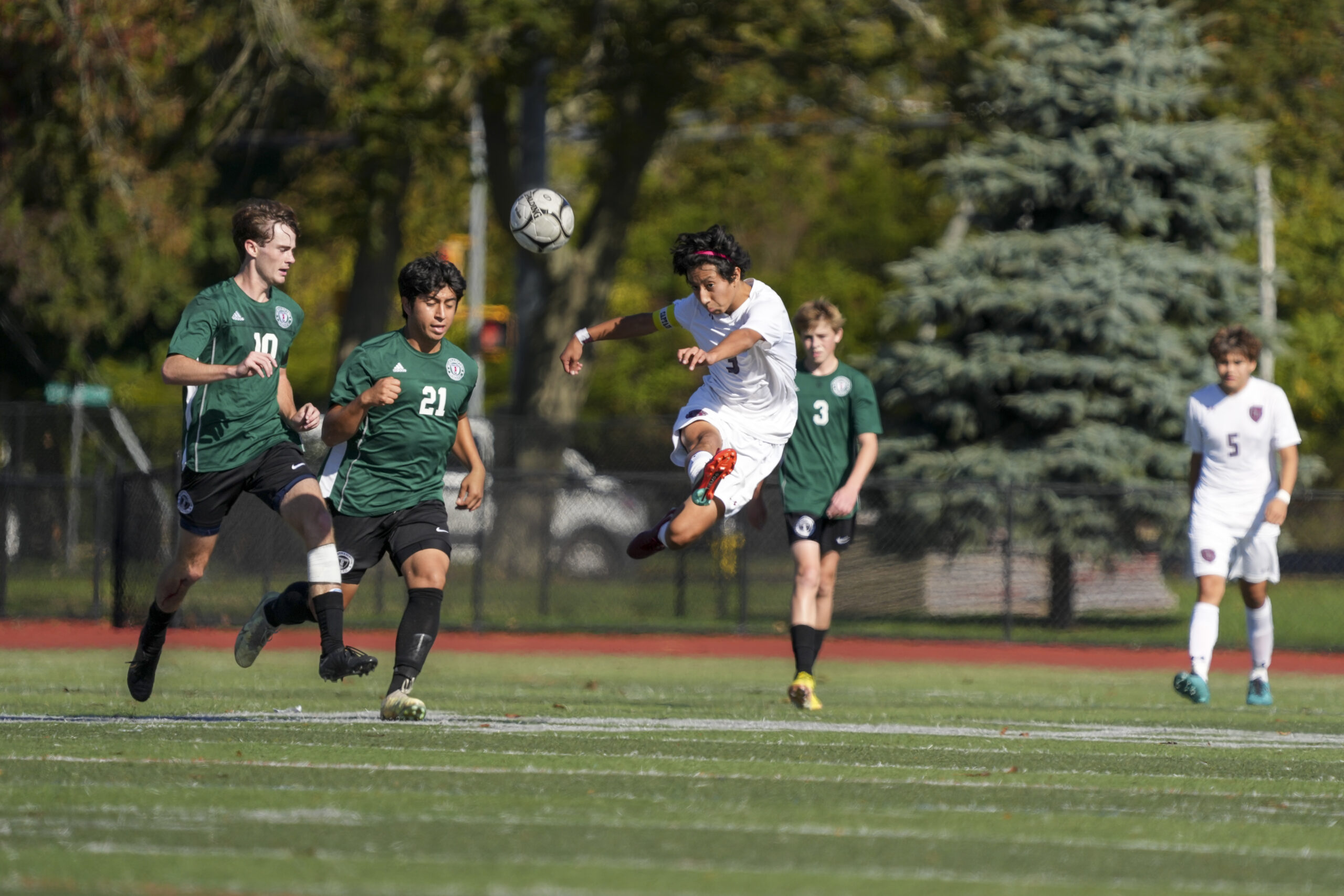 East Hampton junior co-captain Brian Tacuri kicks the ball out of the air.   RON ESPOSITO