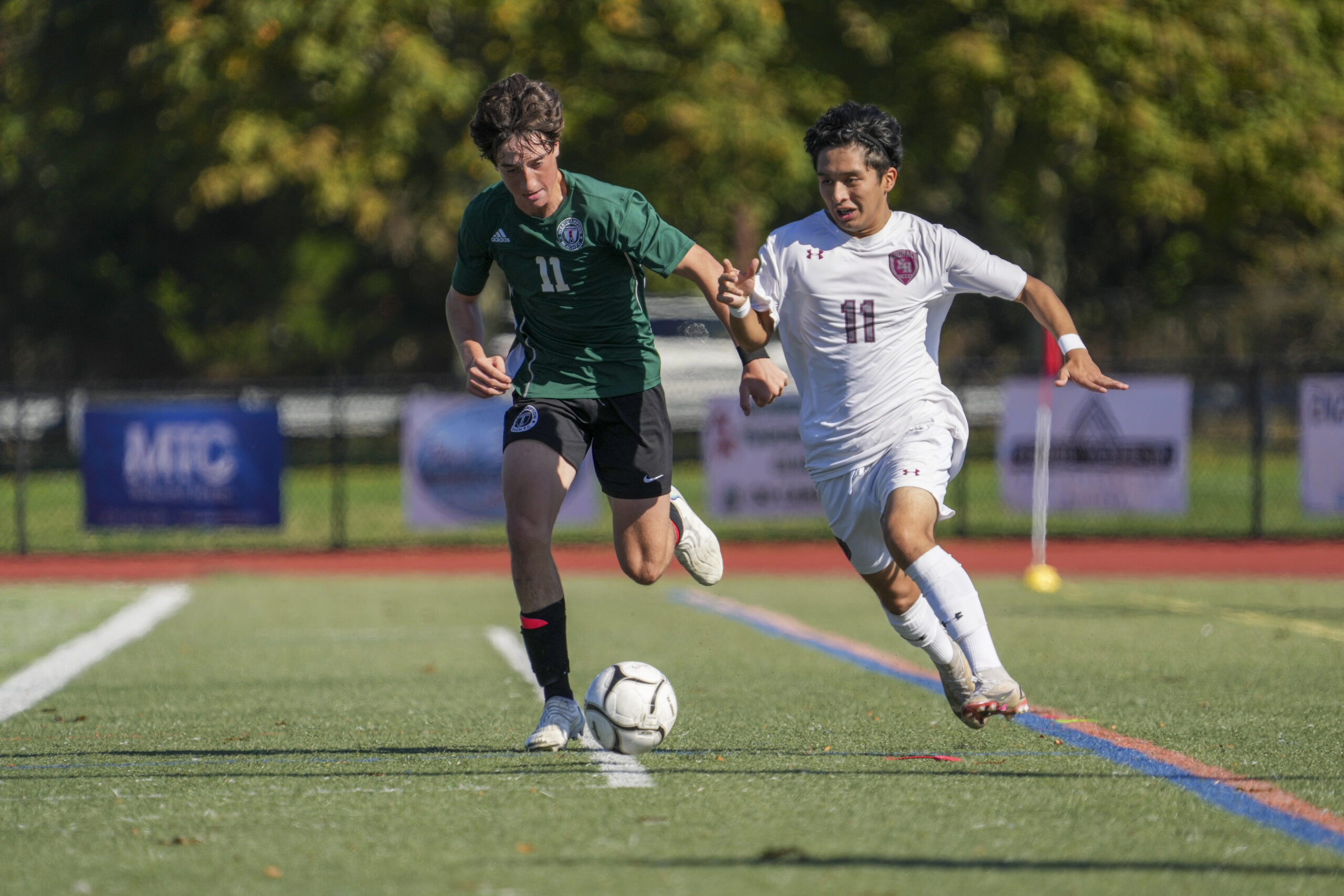 Westhampton Beach junior Lewis Gibbons and East Hampton junior Gary Gutama go after the ball.    RON ESPOSITO