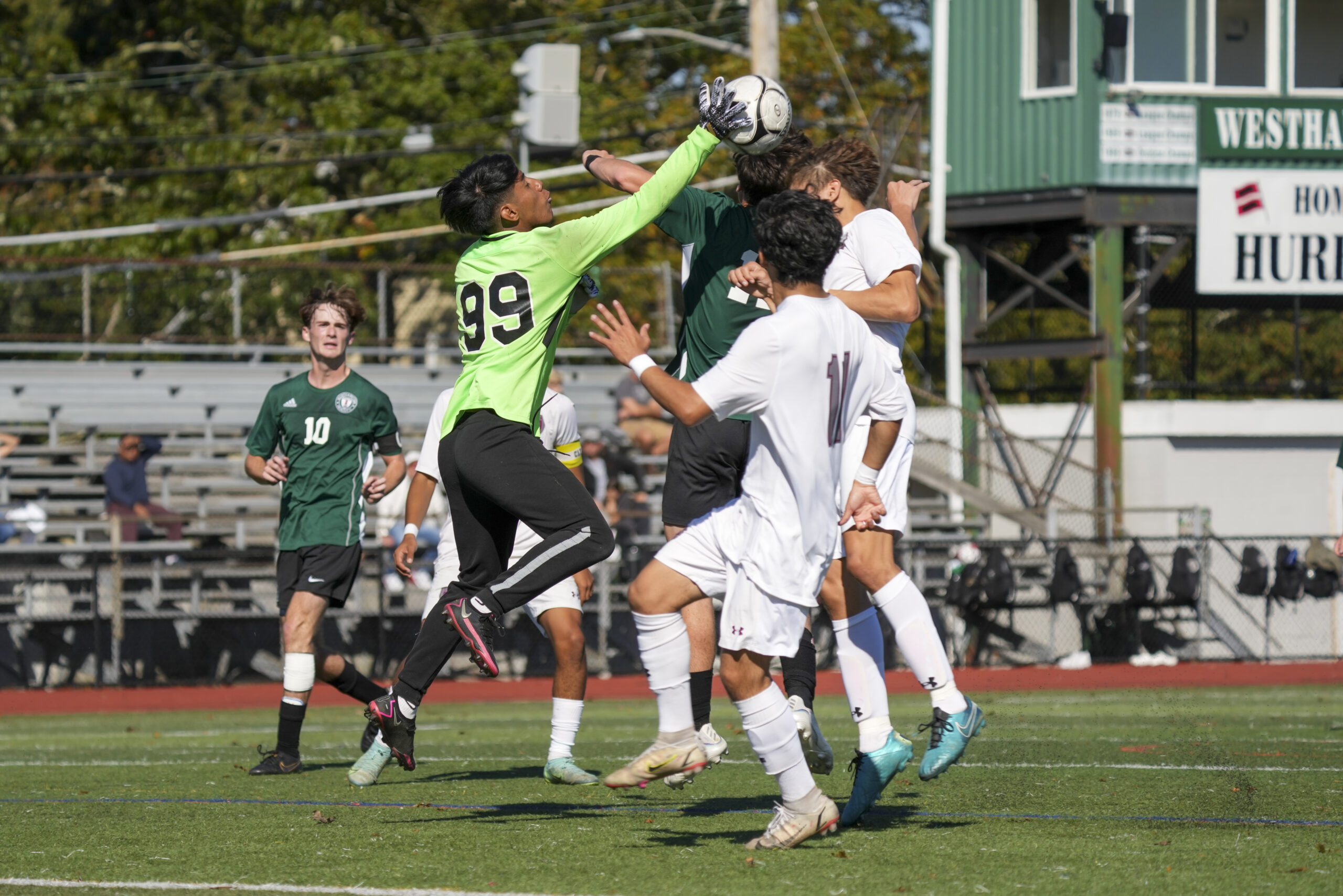 Westhampton Beach senior goalie Alex Ajiataz goes up to punch the ball out.   RON ESPOSITO