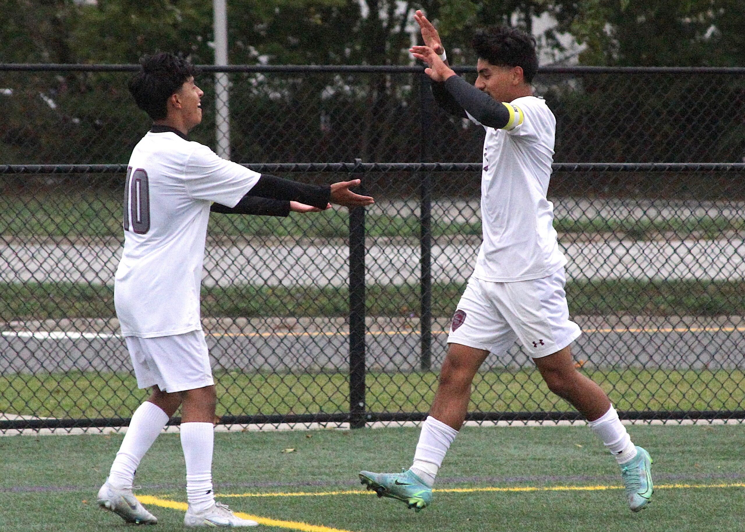 Senior forwards Eric Amijos and Michael Figueroa celebrate connecting for the final goal of the game. DESIRÉE KEEGAN