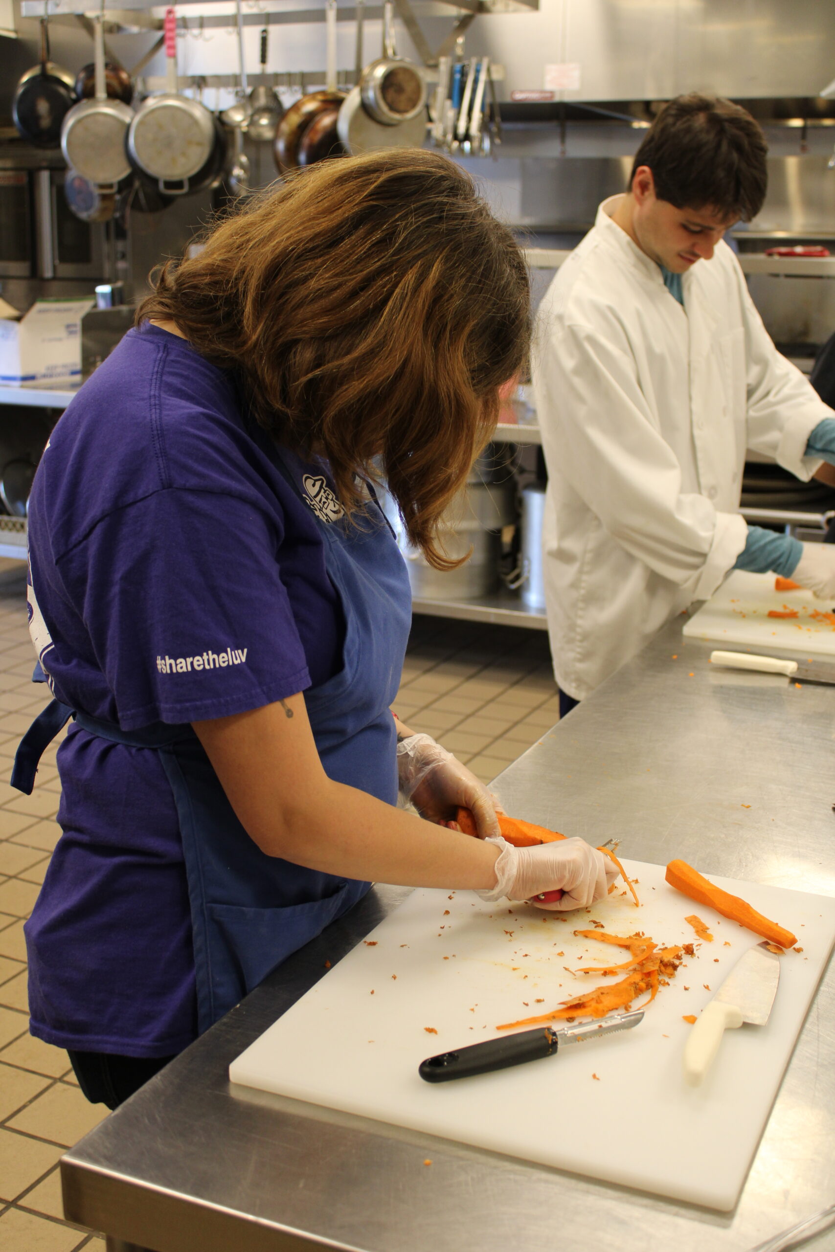 Jenna Carballo chops carrots in the Greek Orthodox Church kitchen as a part of a partnership between US Autism Homes, Luv Michael, and the Greek Orthodox Church. ELIZABETH VESPE