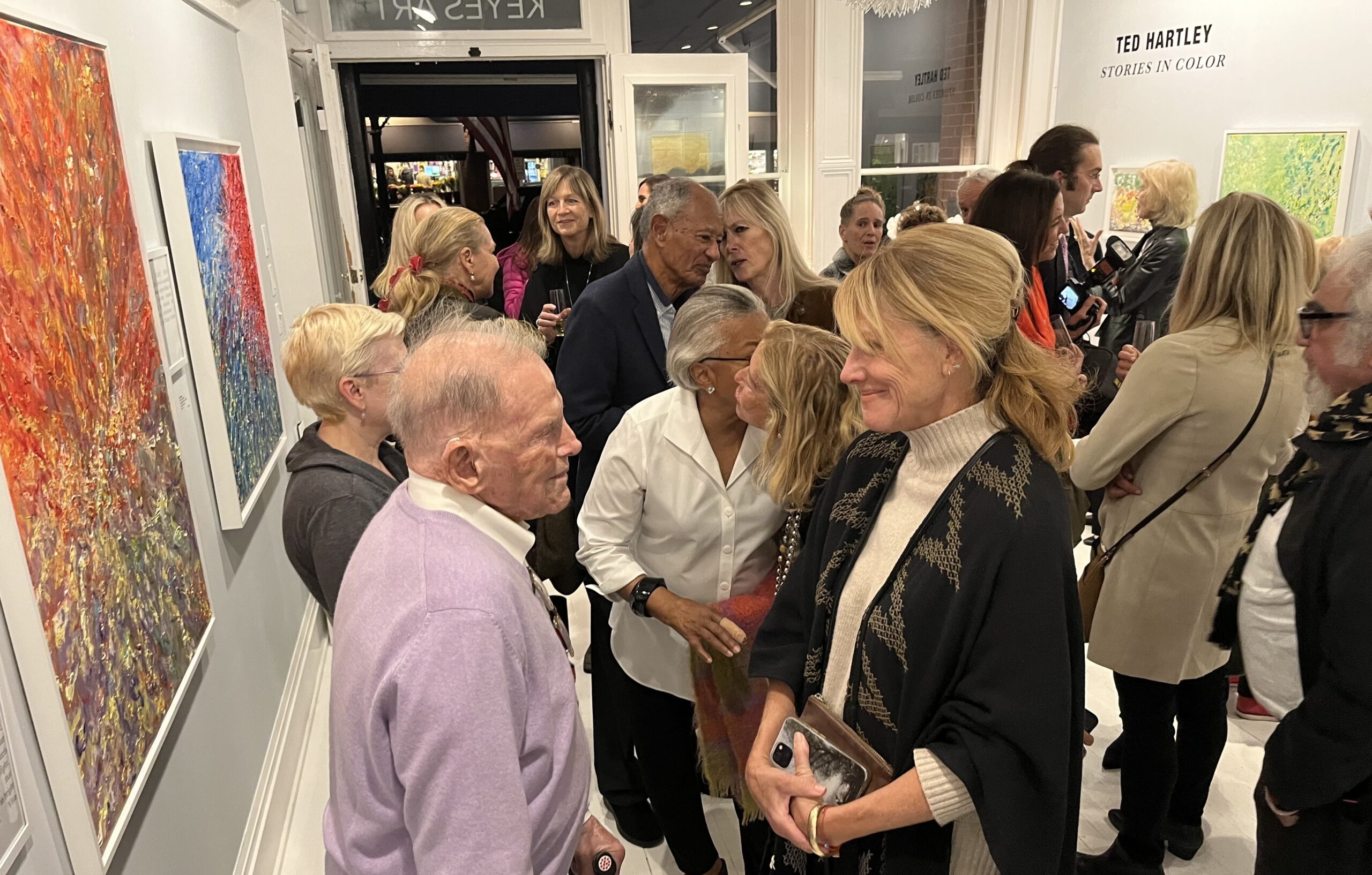 Ted Hartley speaking with guests at the opening of his solo exhibition 