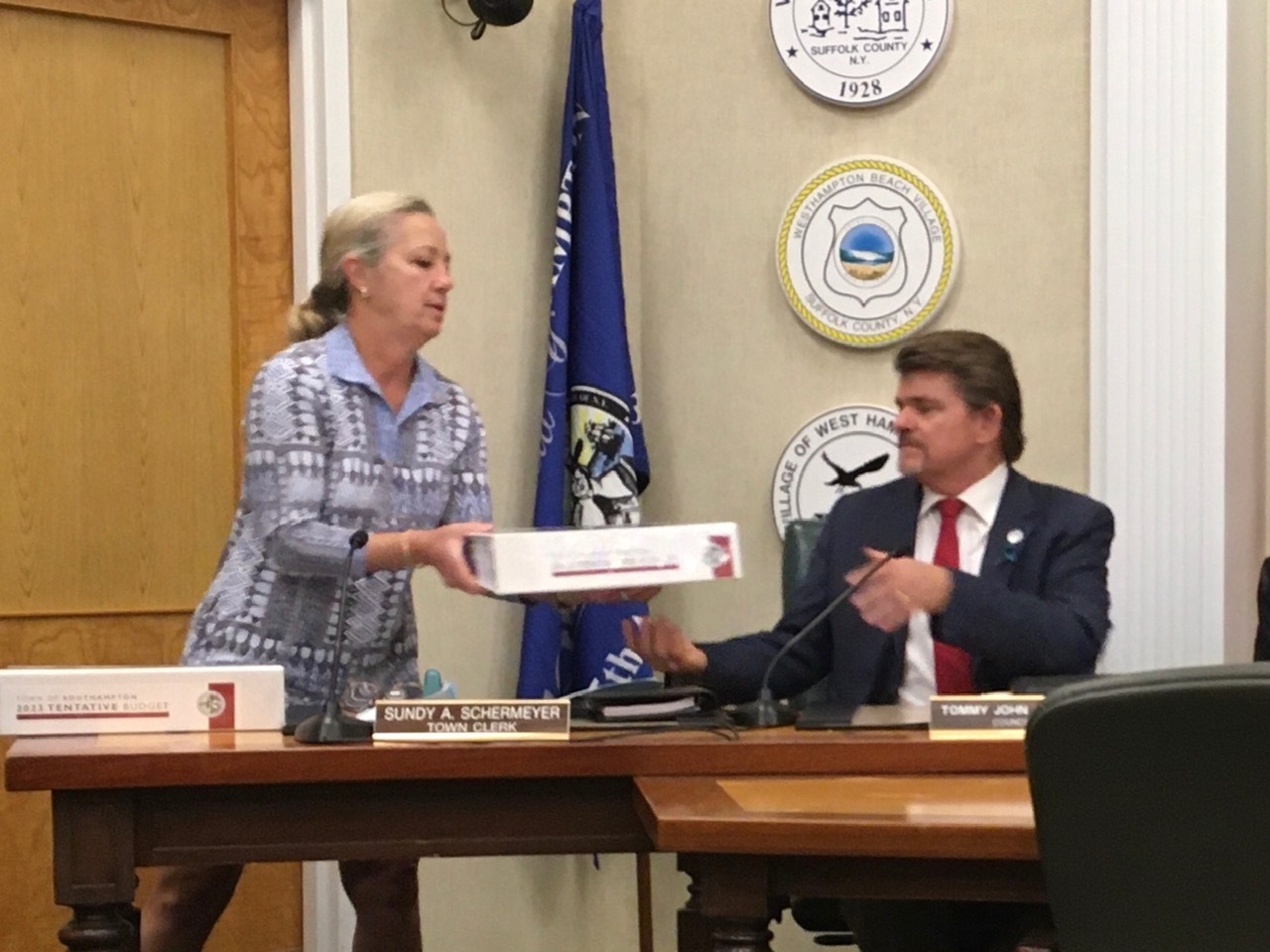 Southampton Town Clerk Sundy Schermeyer distributed  the tentative budget to members of the Town Board. Above Councilman Tommy John Schiavoni accepts the hefty tome.     KITTY MERRILL