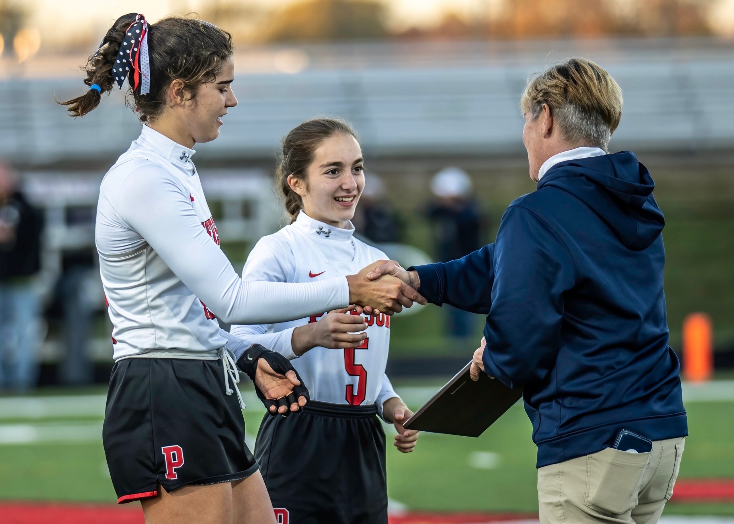 Meredith Spolarich and Mia Gangemi receive the Suffolk County Class C championship plaque from Section XI field hockey chairperson Deb Ferry. MARIANNE BARNETT