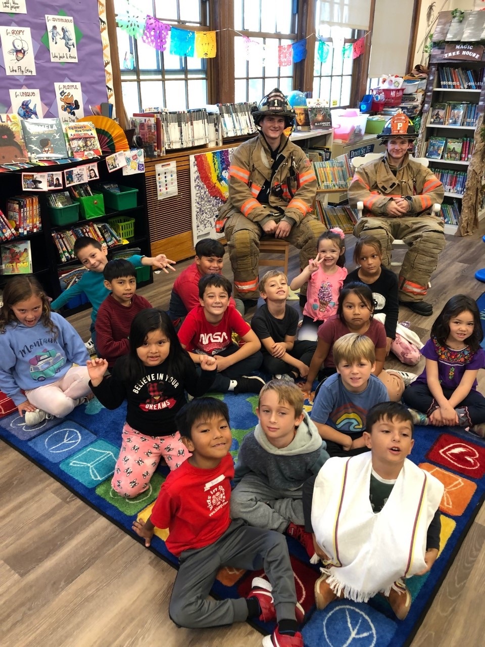 Southampton firefighters Nicholas Maddock and Jagger Maddock were guest readers in the school’s library on October 14. They read “Curious George and the Firefighters” by H.A Ray to the first graders. COURTESY SOUTHAMPTON SCHOOL DISTRICT