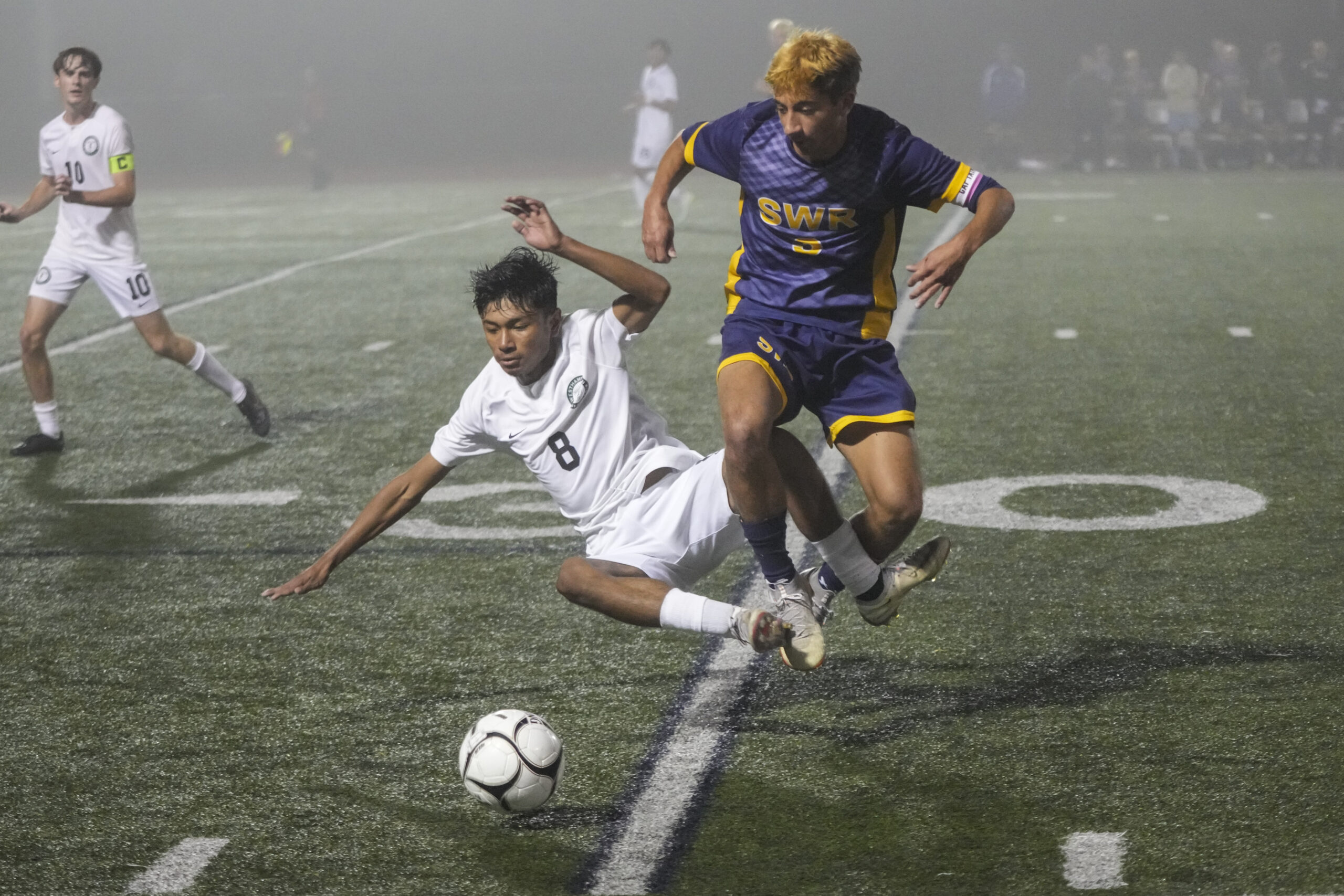 Westhampton Beach junior Deyvid Cabrera gets tangled up with Shoreham-Wading River senior Nicholas Nowak.   RON ESPOSITO