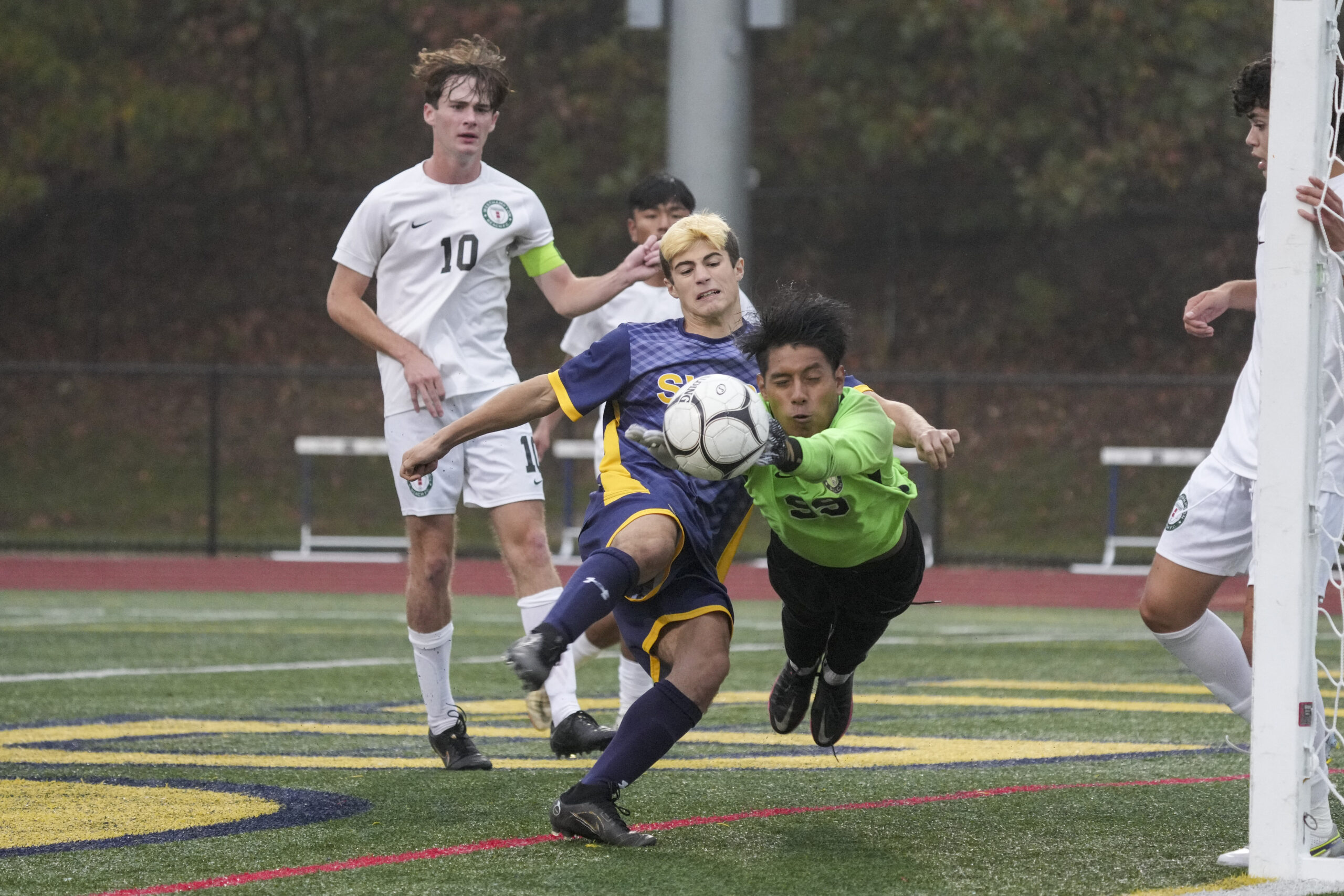 Goalie Alex Ajiataz makes a save on a ball that was crossed into the box. The Westhampton Beach senior took an inadvertent boot to the ribs on the play and had to come out of the game for a play before entering back in.     RON ESPOSITO