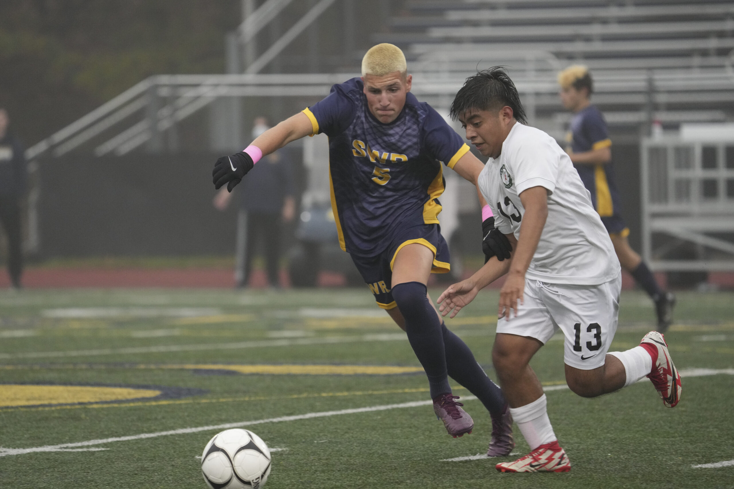 Westhampton Beach senior Pablo Vicente and Shoreham-Wading River senior Craig Anderson go after the ball.    RON ESPOSITO