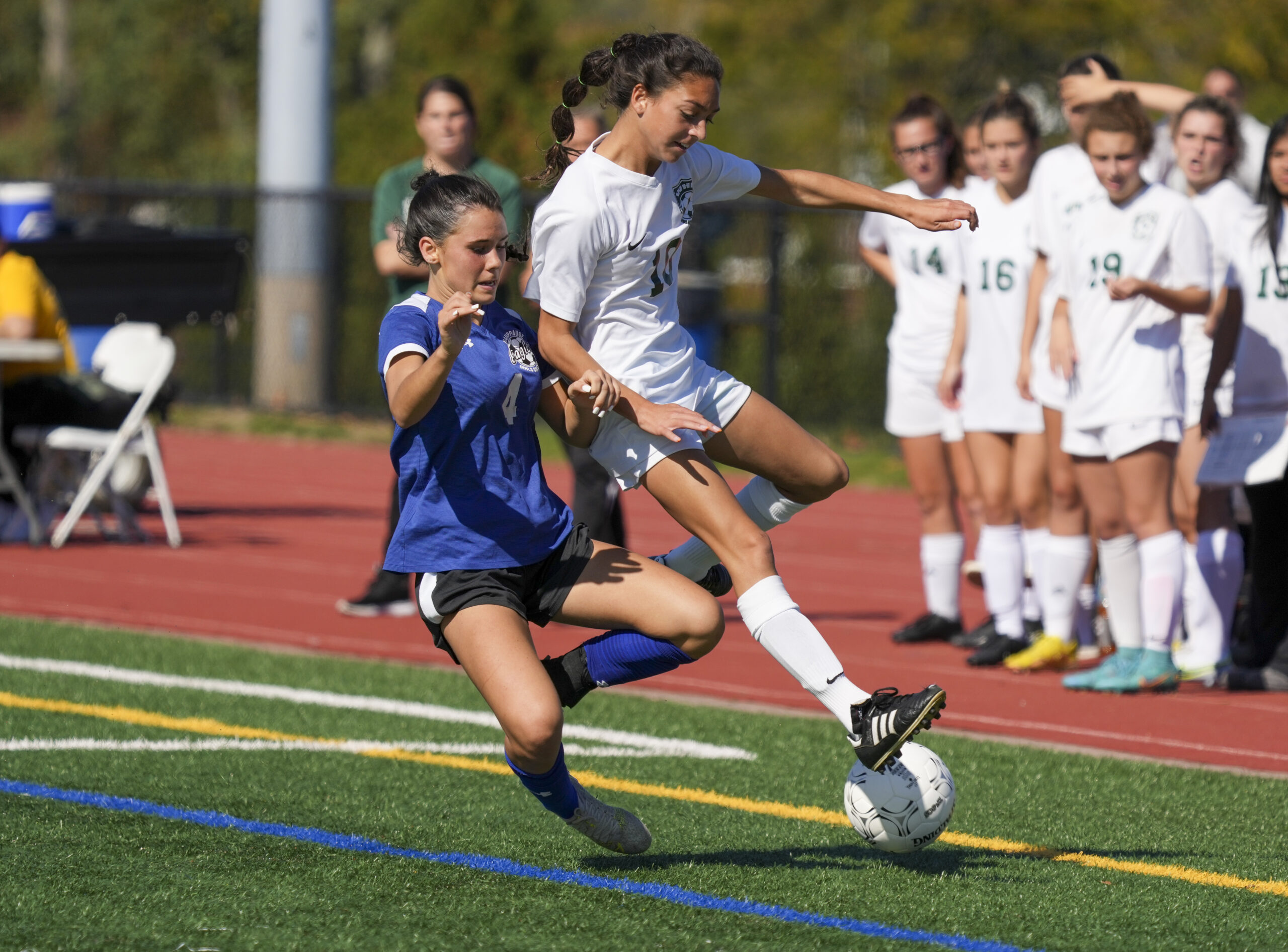 Westhampton Beach sophomore Mia Valenzuela and a Hauppauge player go after the ball.   RON ESPOSITO