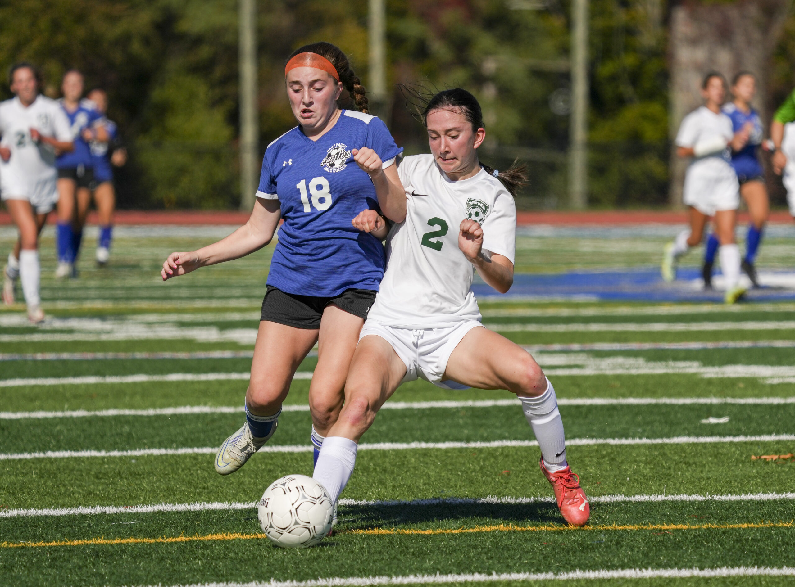 Westhampton Beach sophomore Lily Strebel and a Hauppauge player jostle for the ball.   RON ESPOSITO