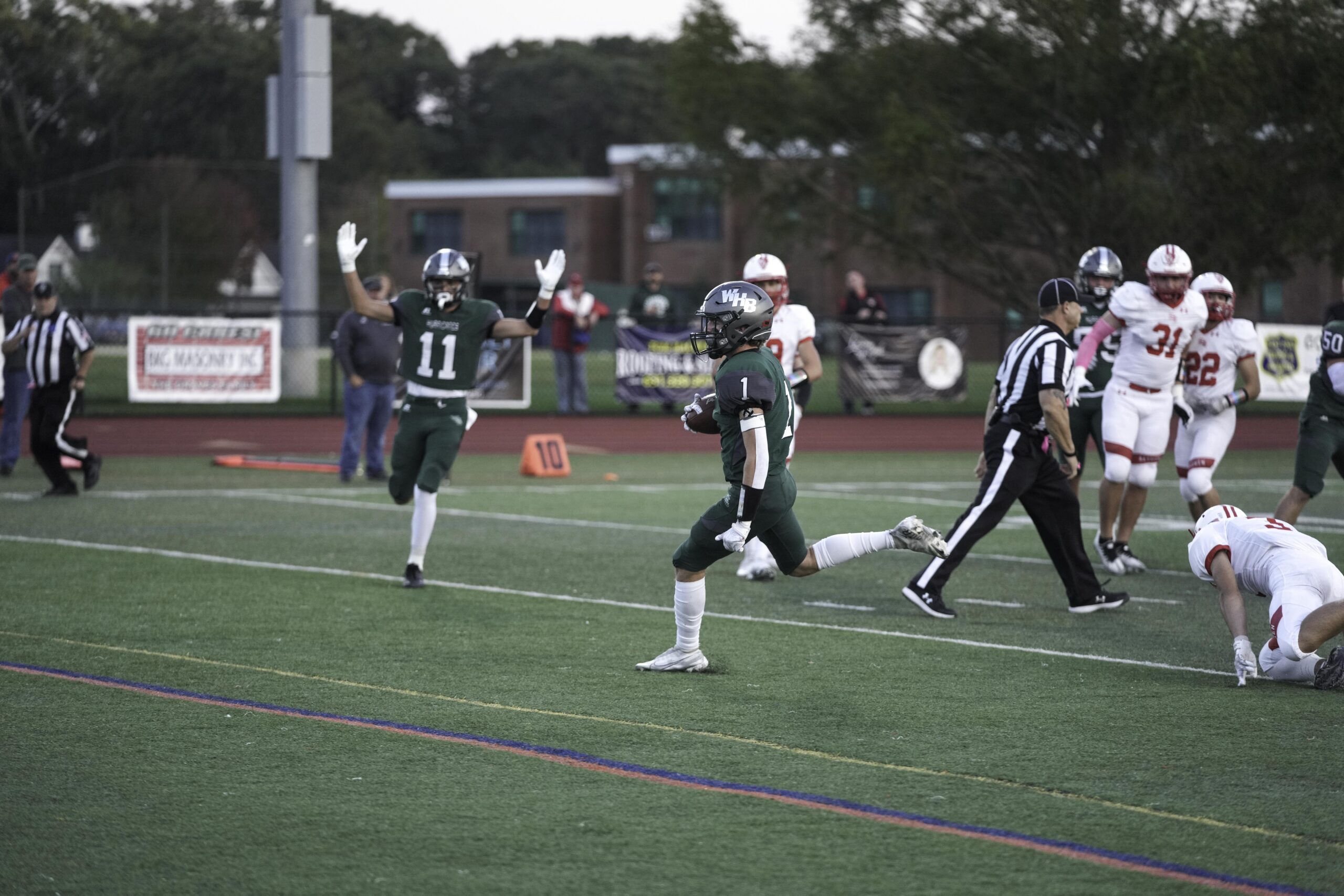 Michael LoRusso raises his arms as teammate Kevin Smith crosses the goal line for the game's first touchdown in the first quarter.    RON ESPOSITO