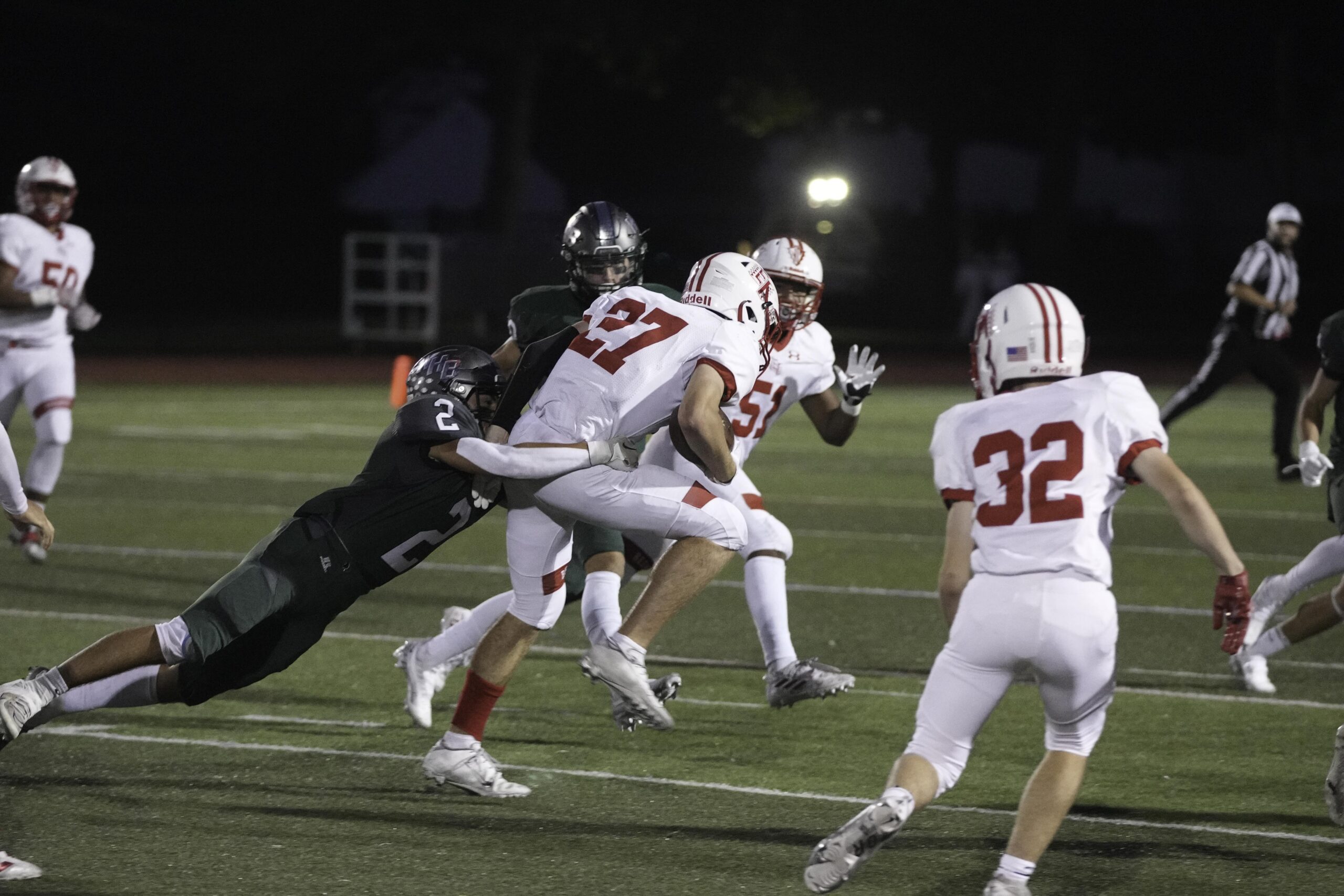 Westhampton Beach junior Gianni Amodemo makes first contact on an East Islip player and tries to drag him down.    RON ESPOSITO