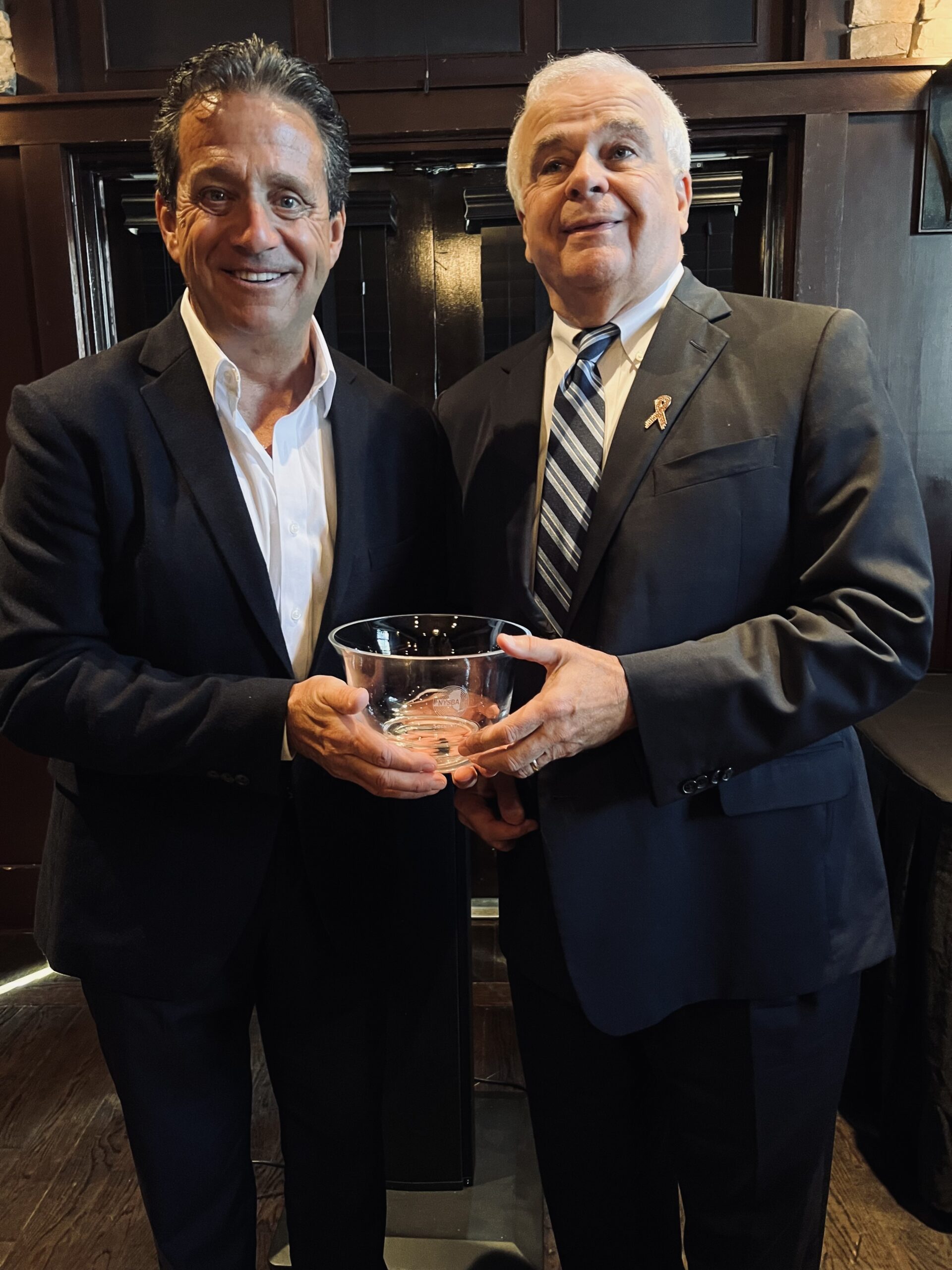 Bill Evans, left, owner of WLNG 92.1FM recently accepted an award from the New York State Broadcasters Association recognizing the station’s outstanding public service efforts in the 2022 “Serving New York Awards.