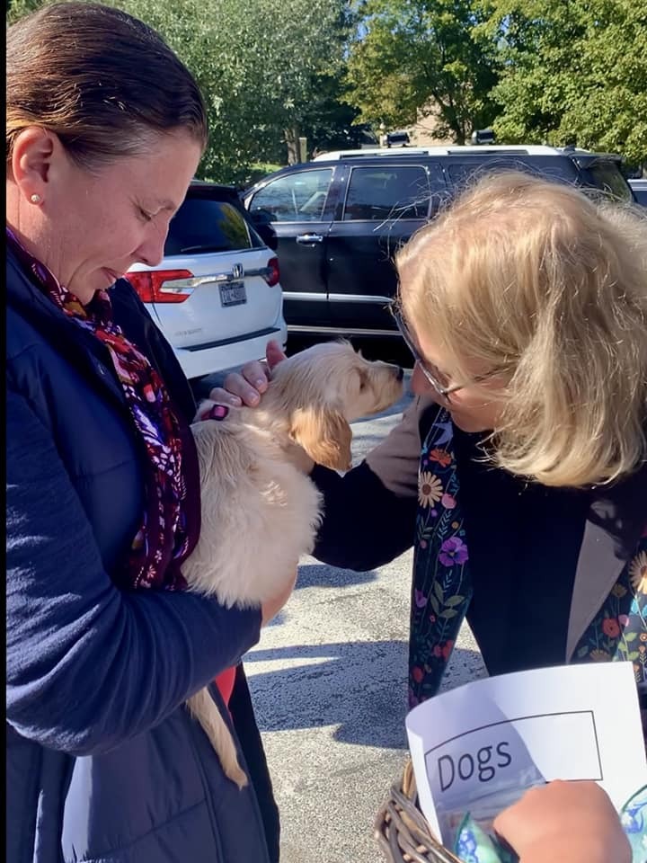 Nancy Remkus blesses her niece Maria's dog during the Blessing of the Pets at the Old Whalers' Church last weekend. COURTESY NANCY REMKUS