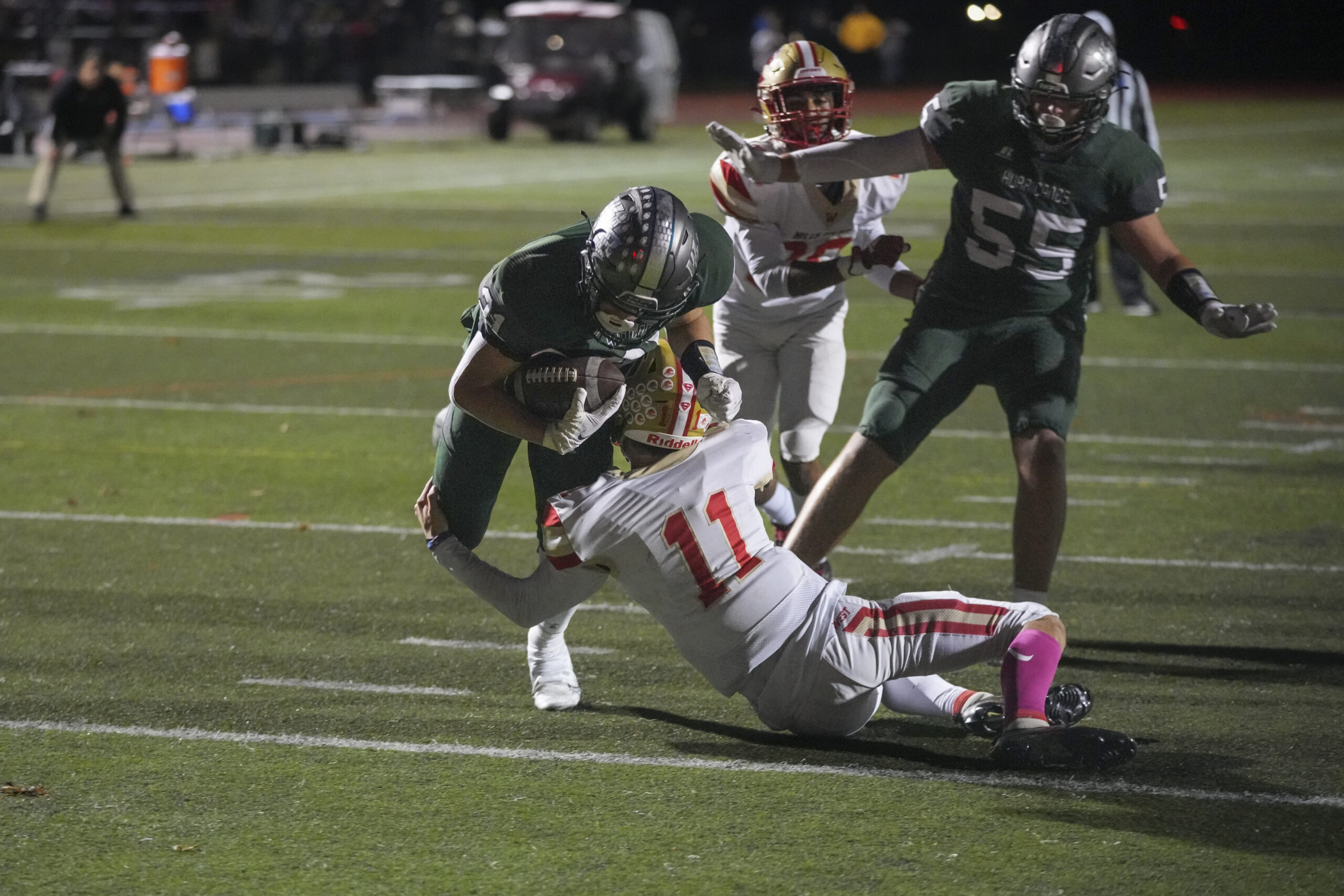 Sophomore Brody Schaffer plows over a Hills West defender for the Hurricanes first touchdown of the game in the second quarter.    RON ESPOSITO