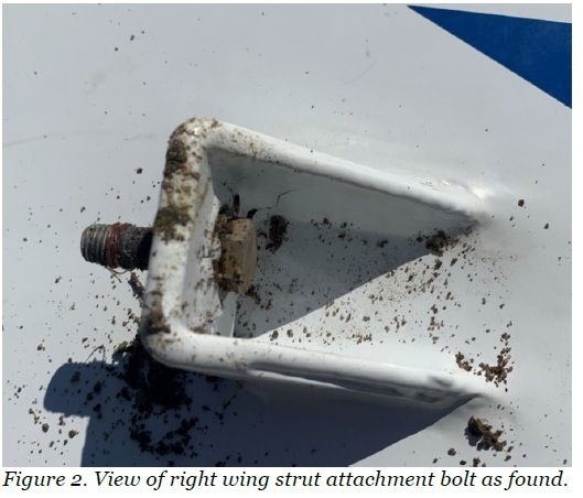 A close-up photo of the attachment point and bolt that connected a key wing strut to the wing. Federal crash investigators noted the bolt was missing a nut. The same bolt connection and a missing nut were spotlighted as for a 2019 crash of the same model of plane in Italy.