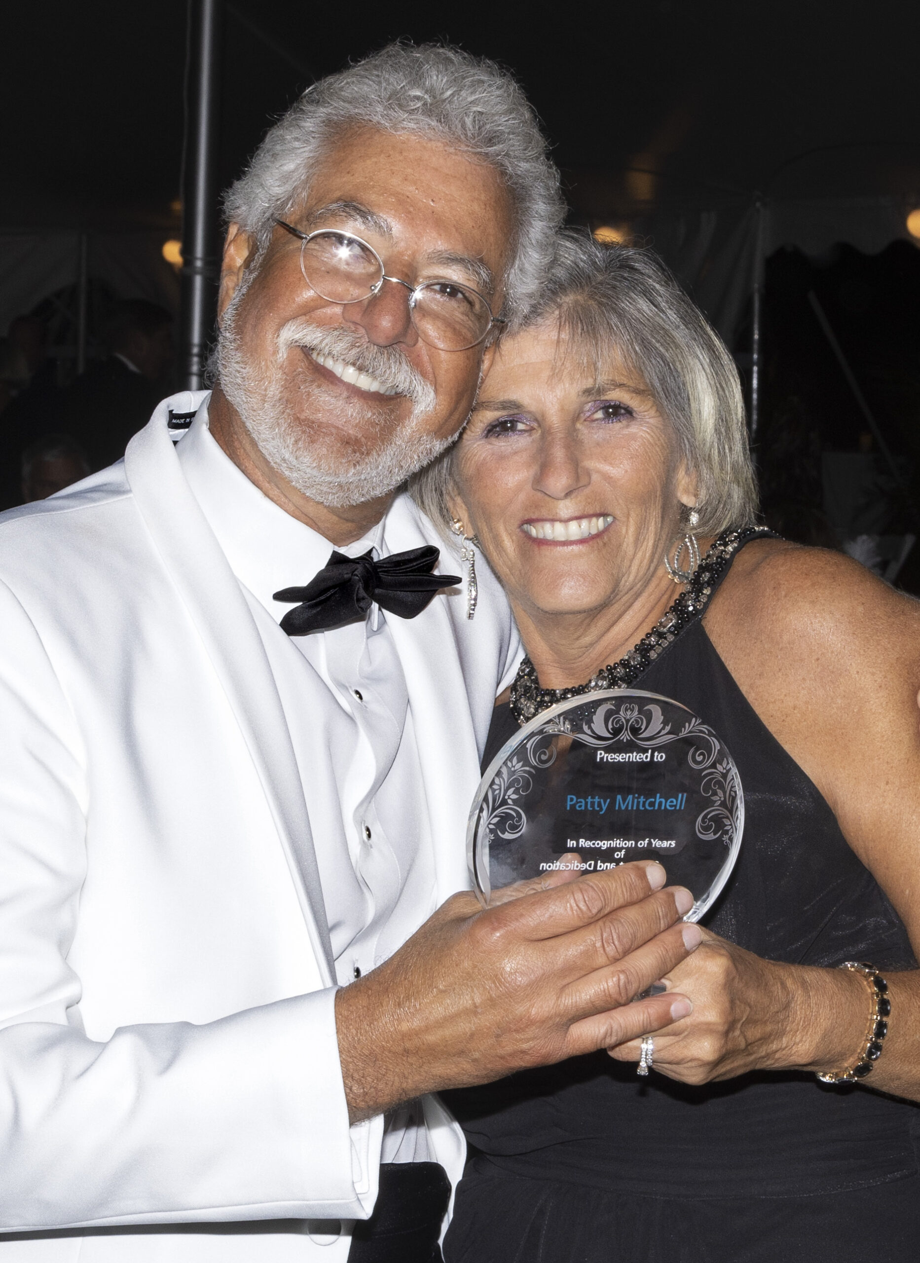 Patty Mitchell was given an award honoring her years of dedication to Operation International by Medhat Allam, M.D.,  at the Black & White Party, held October 8 at the Watermill Center. COURTESY CHARLIE GRUBB