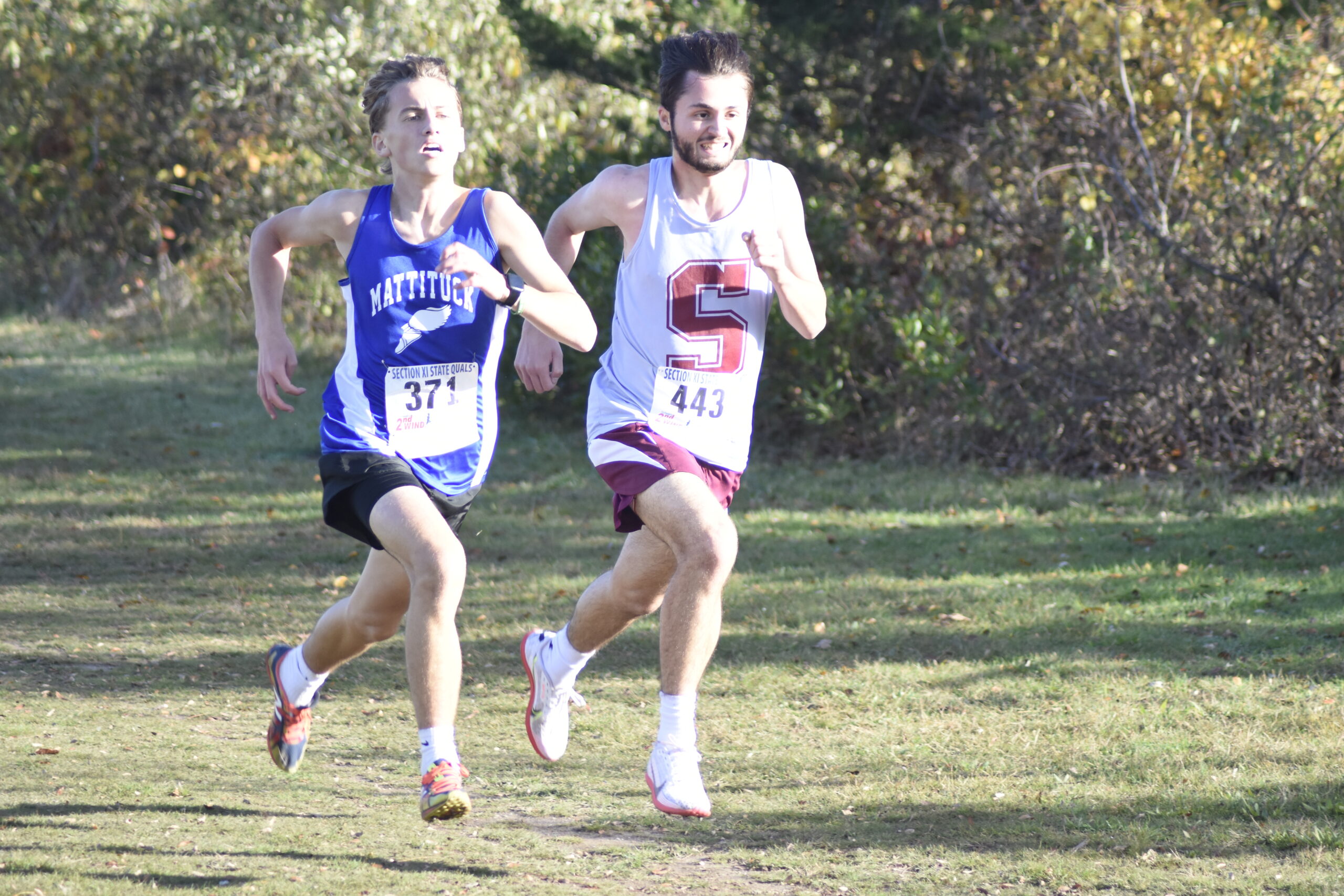 Southampton senior Evan Simioni and Mattituck sophomore Matt Rosato race toward the finish line.   DREW BUDD