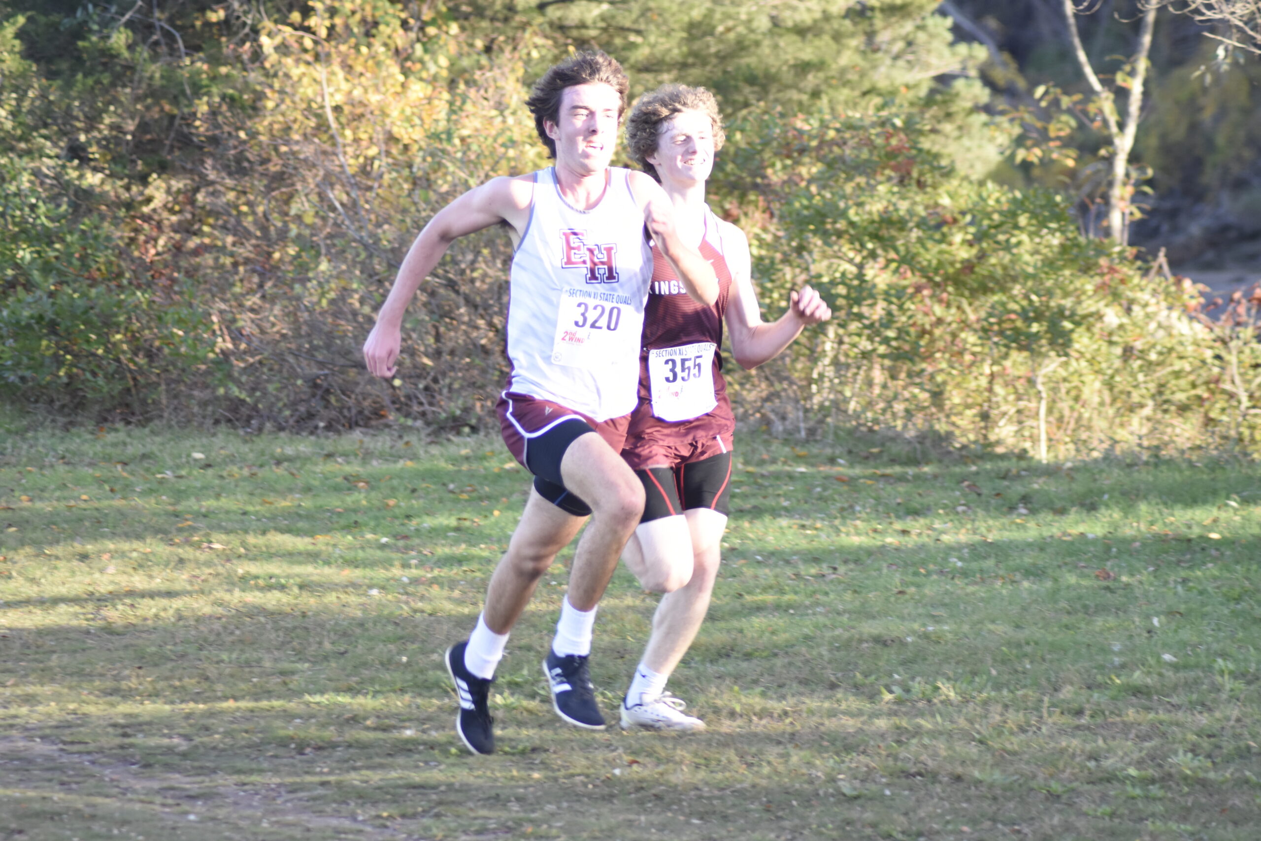 East Hampton junior Liam Fowkes finishes with a burst to outrun Kings Park sophomore Raymond Fanelli to the finish line.   DREW BUDD