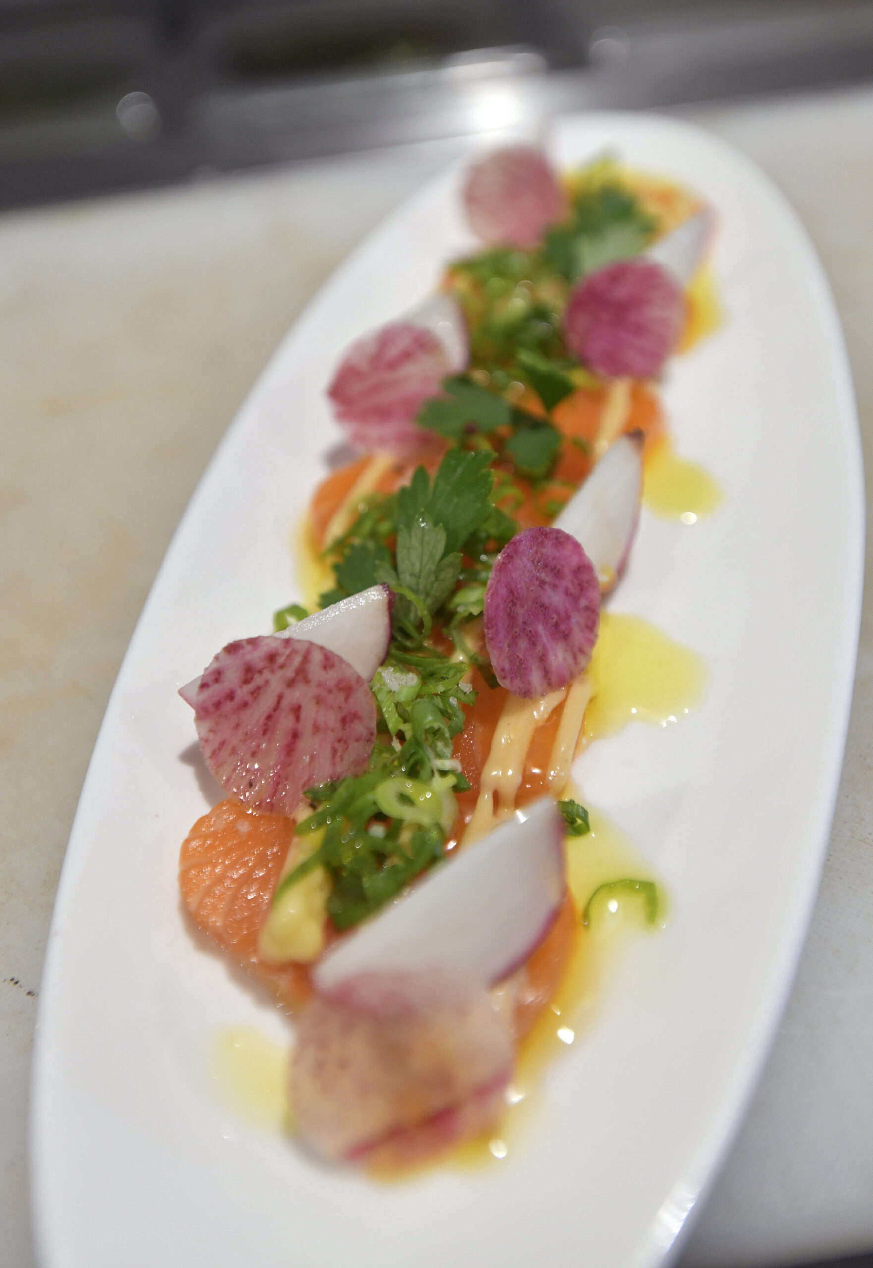 From the raw bar, salmon with hearts of palm, radishes, jalapeno, and miso dressing.   DANA SHAW