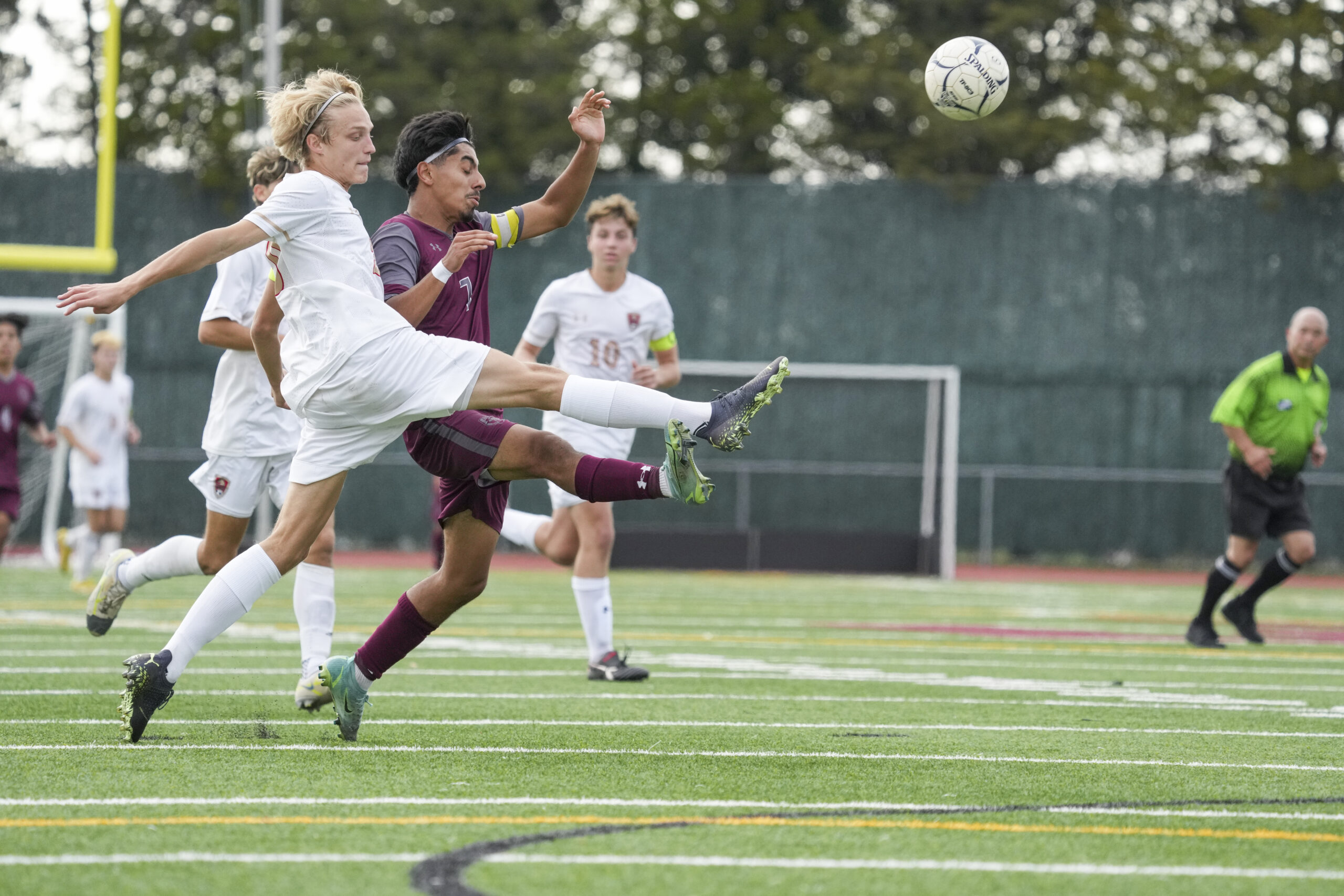 East Hampton senior co-captain Michael Figueroa tries to leap in front of a Hills West clear.    RON ESPOSITO