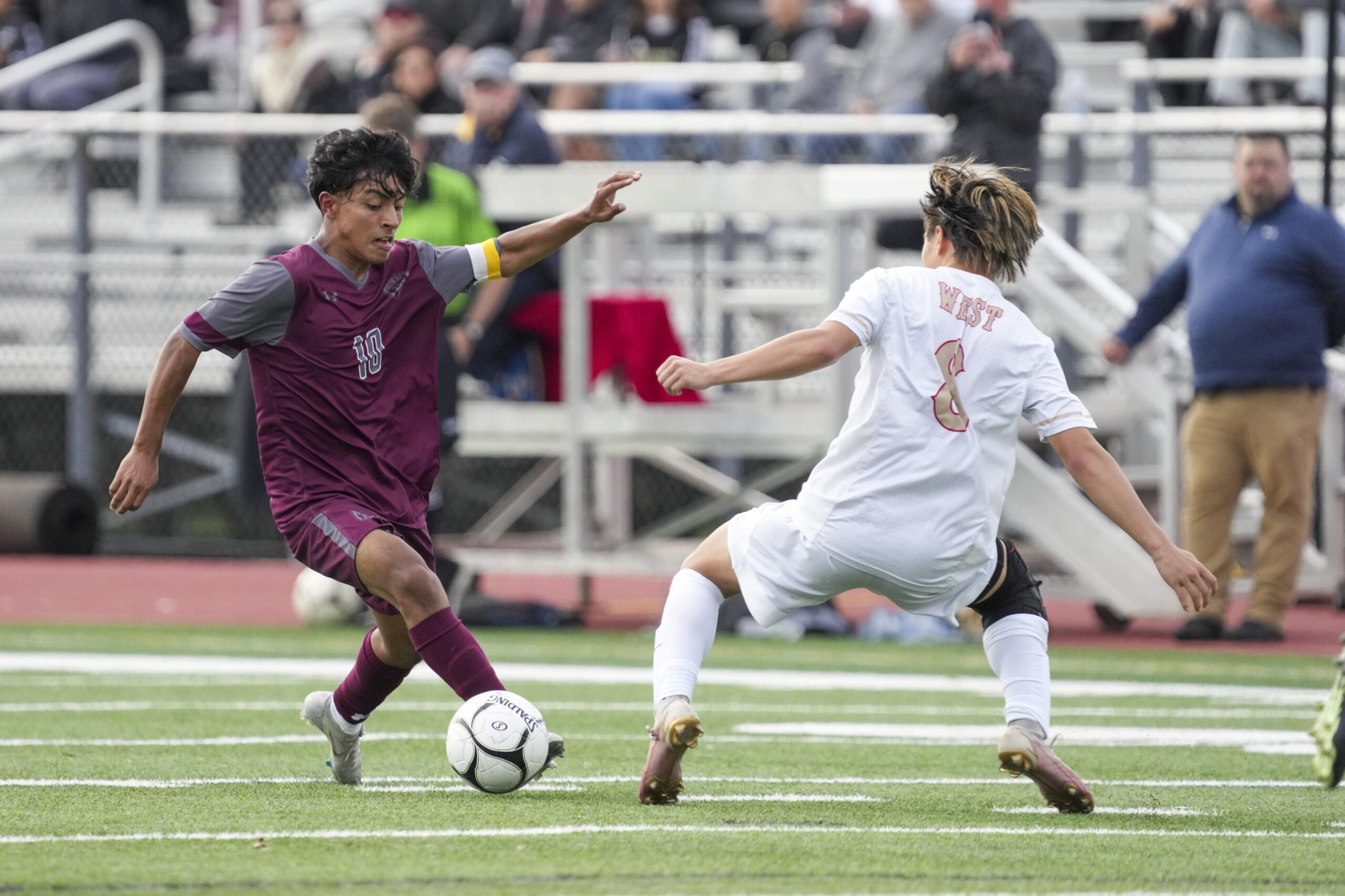 East Hampton's Eric Armijos makes a Hills West player miss.   RON ESPOSITO