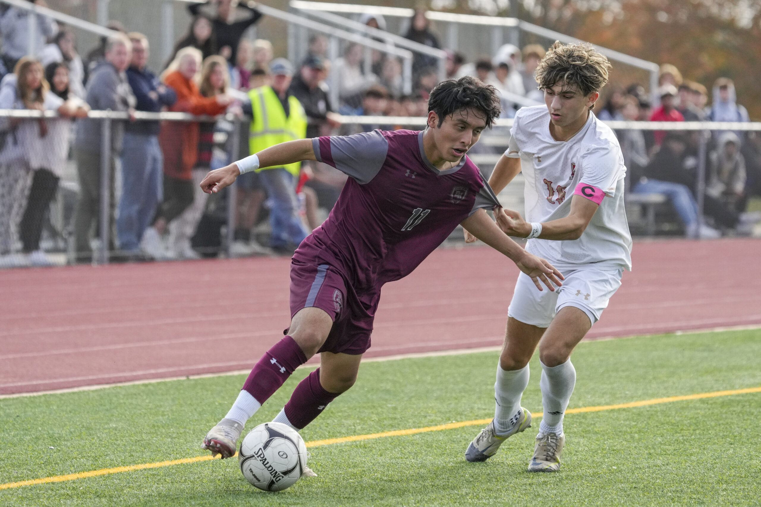 East Hampton junior Gary Gutama has his jersey pulled by a Hills West defender.    RON ESPOSITO