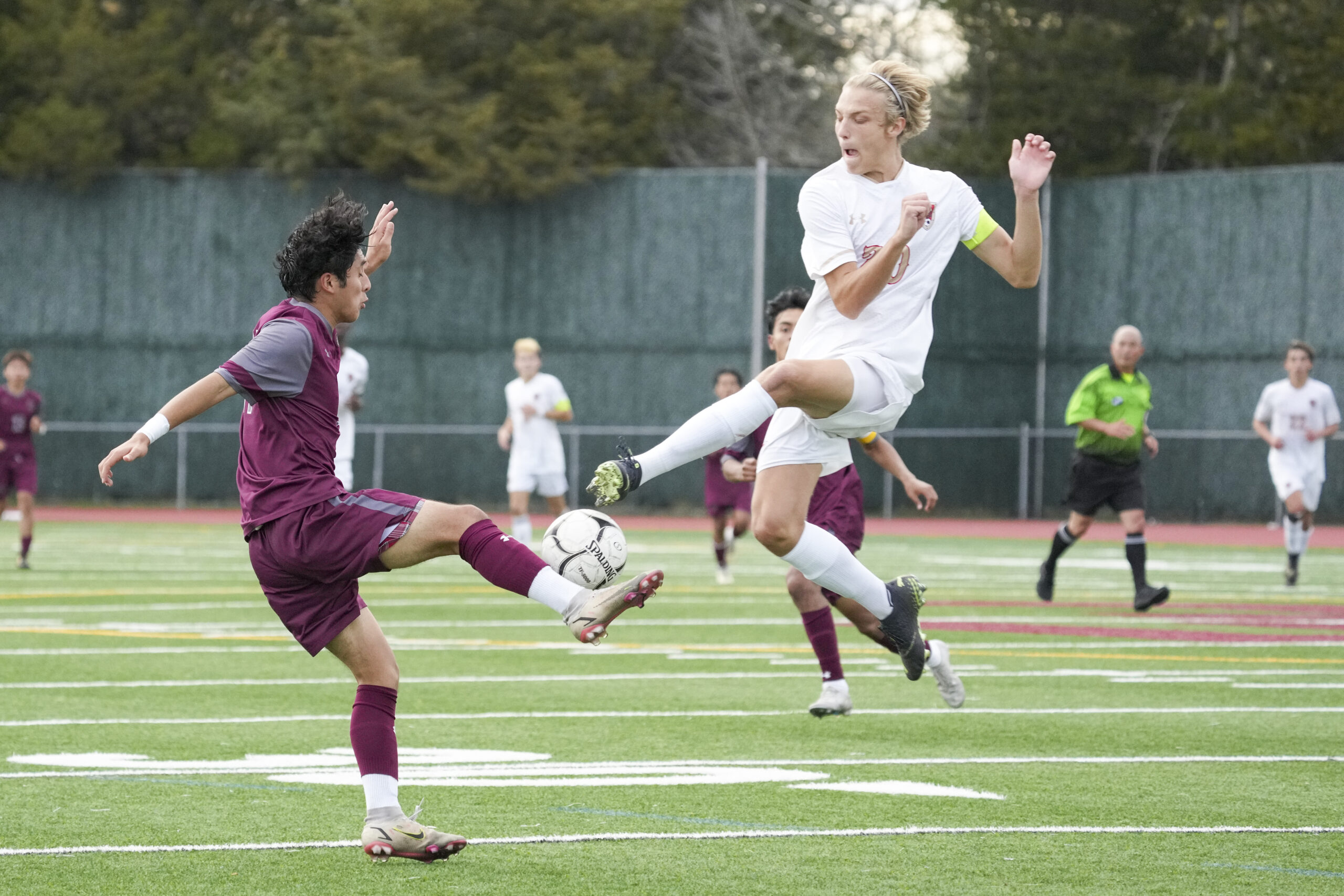 East Hampton junior Gary Gutama goes to clear the ball but is pressured by a Hills West player.    RON ESPOSITO