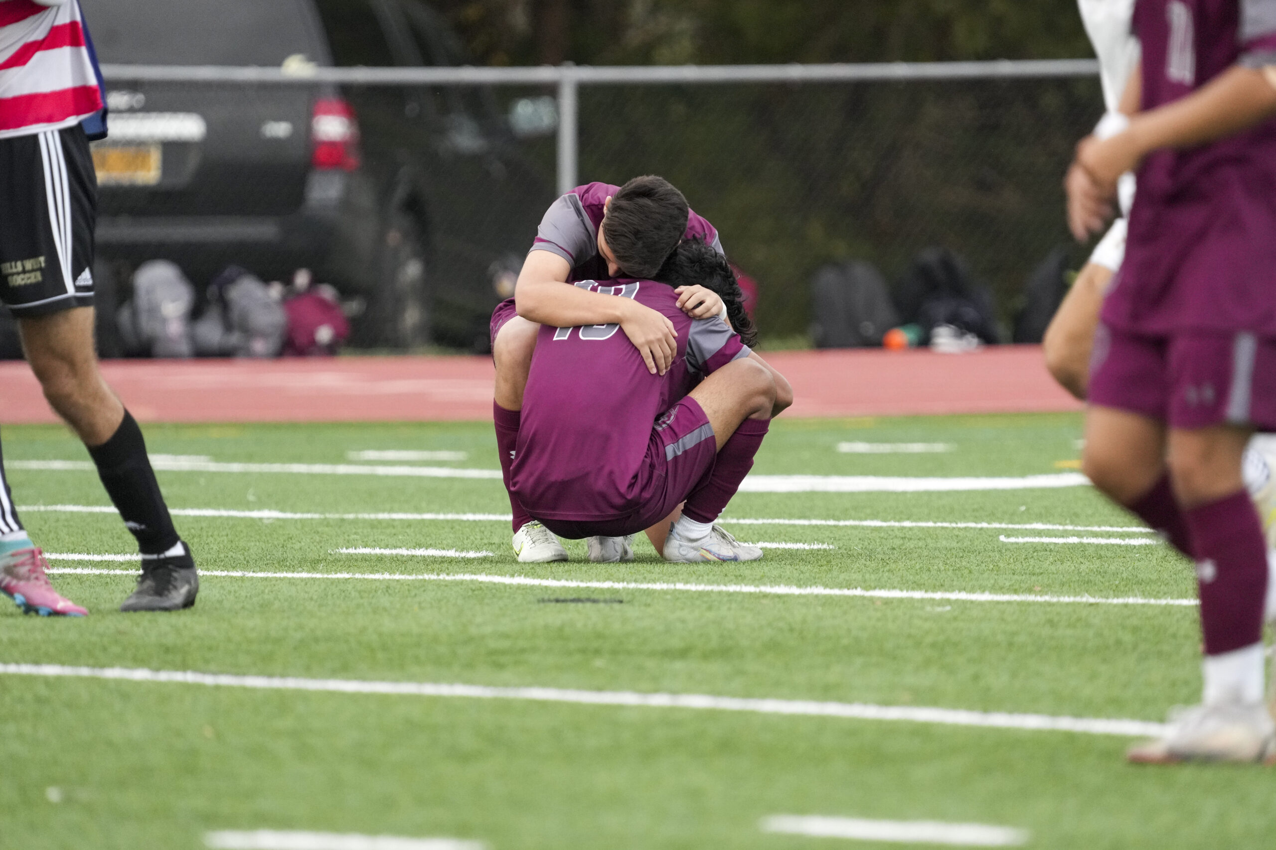 Bonac players console each other after a tough 1-0 loss to Hills West in the county semifinals on Monday.    RON ESPOSITO