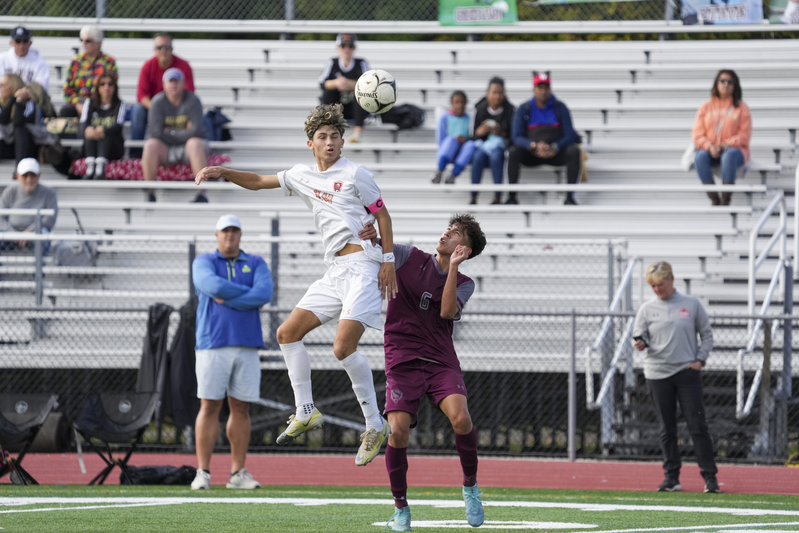 East Hampton junior John Bustamante pressures a Hills West player going up for the ball.   RON ESPOSITO