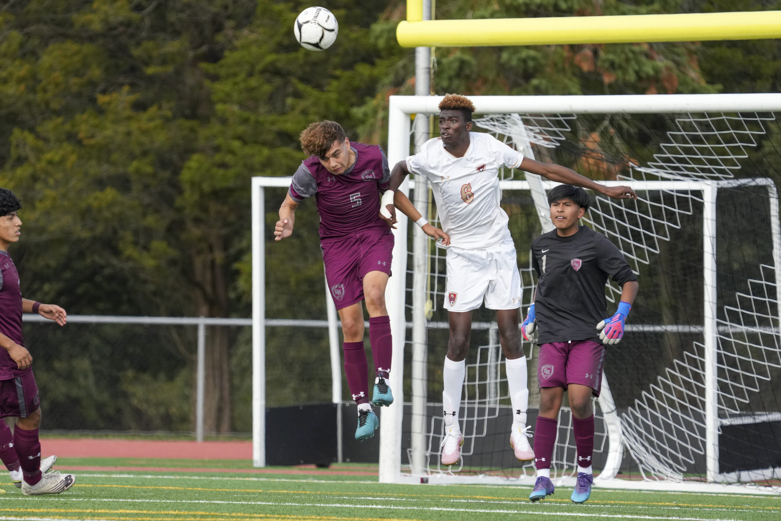 Junior Kevin Hilario heads the ball out of Bonac's defensive end.    RON ESPOSITO